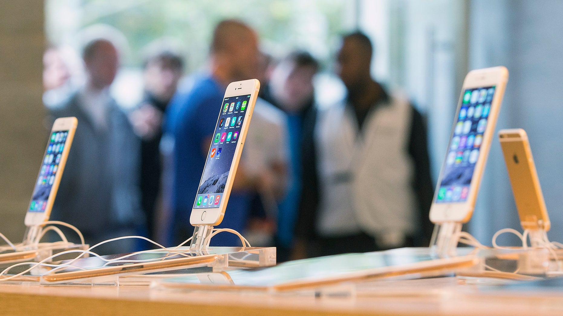 Customers stand in line at the Apple store in Berlin, as they wait to buy the newly released iPhone 6 September 19, 2014.