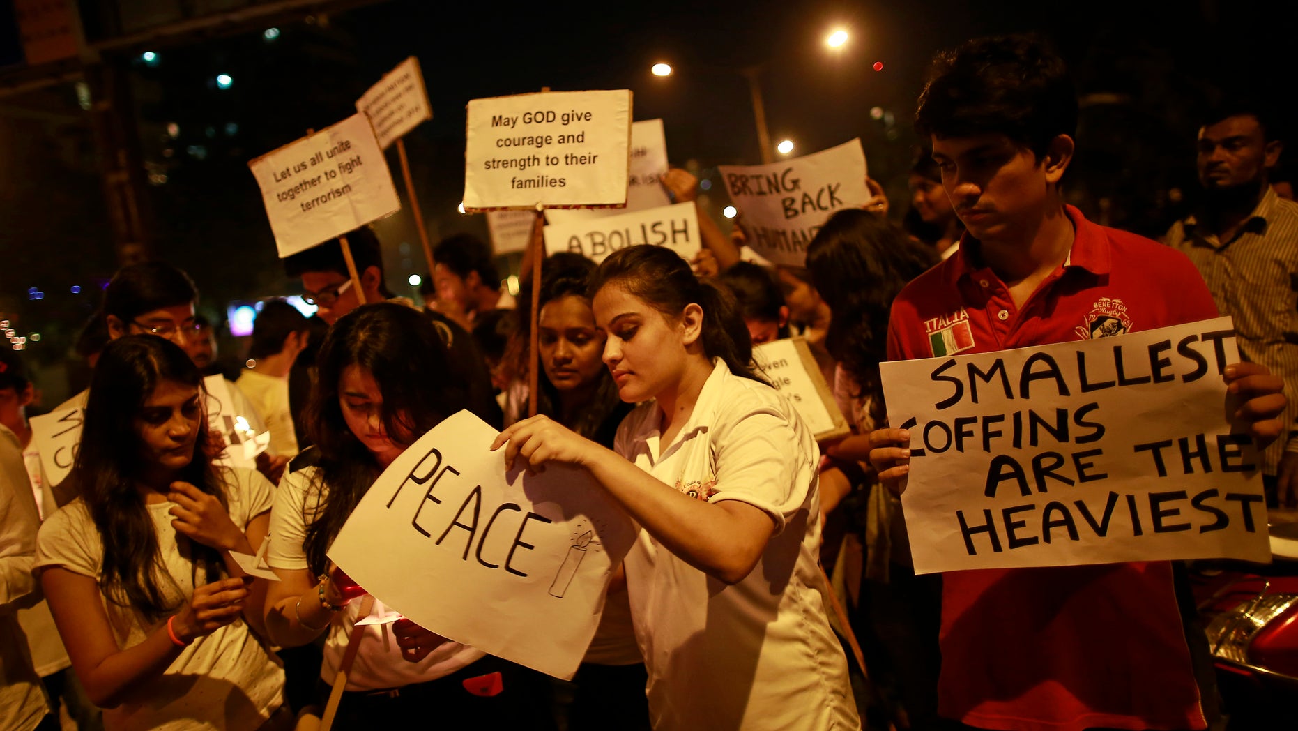 Dec. 22, 2014: Students hold candles and placards for the victims of an attack at the Army Public School at Peshawar in Pakistan. (Reuters)