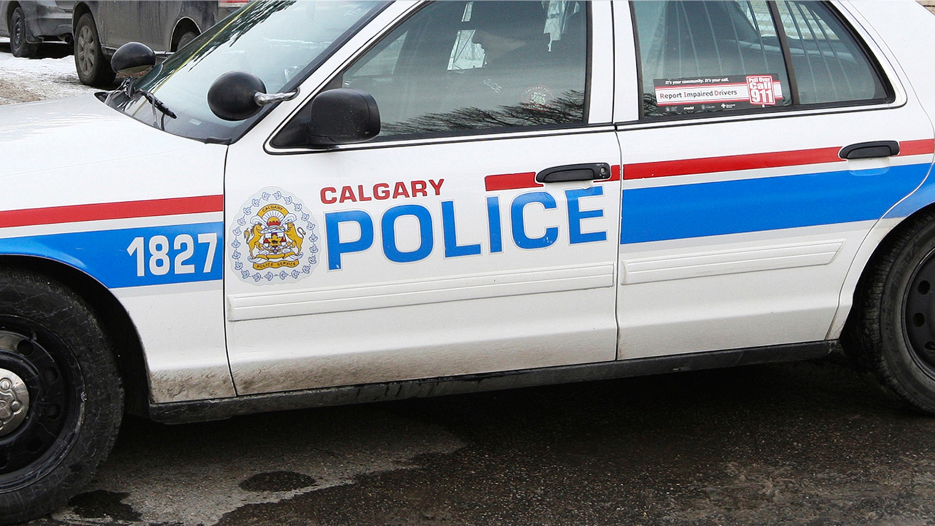 Calgary police said a man's body was found lodged behind a wall in a women's public bathroom.