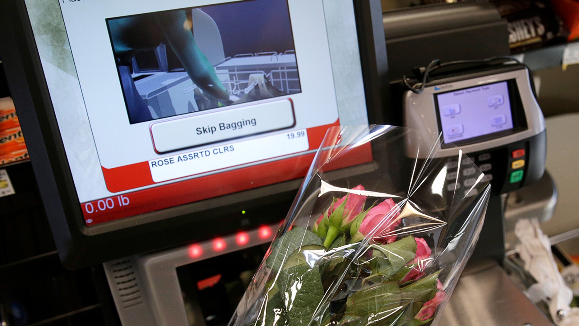 Flowers are scanned at a self check out station.