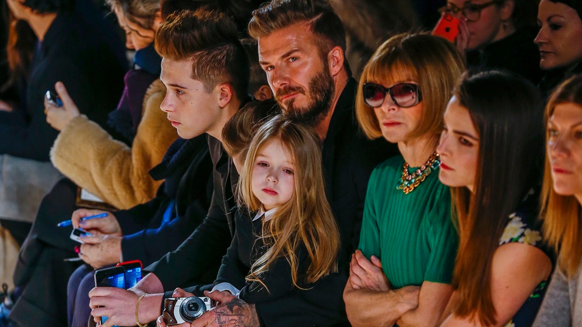 David Beckham with daughter, Harper, at New York Fashion Week event. (Reuters)