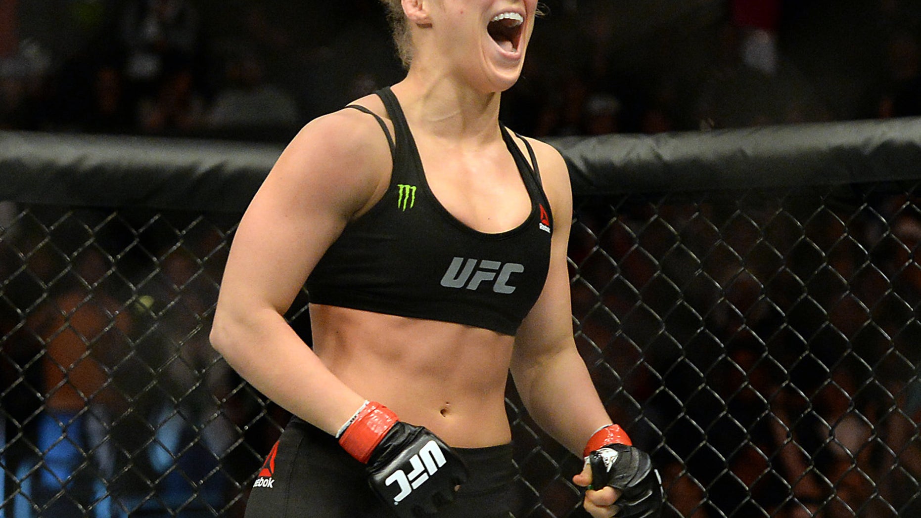 Feb 28, 2015; Los Angeles, CA, USA; Ronda Rousey (red gloves) reacts after defeating Cat Zingano (not pictured) during their women's bantamweight title bout at UFC 184 at Staples Center. Rousey won in 14 seconds of the first round. Mandatory Credit: Jayne Kamin-Oncea-USA TODAY Sports - RTR4RL9J
