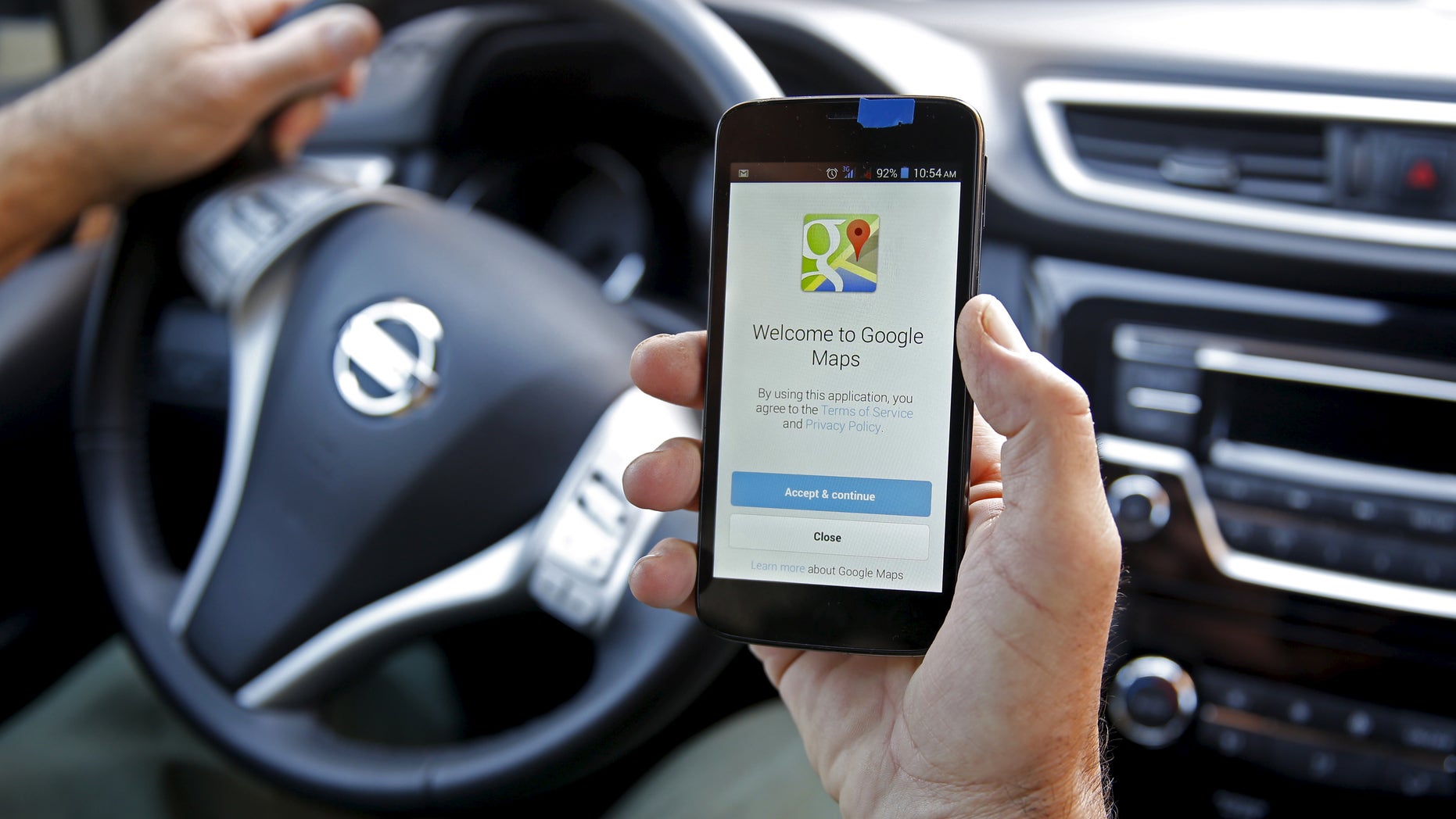 A man holds a smartphone, with the Google Maps app open, in Sarajevo, April 15, 2015. (REUTERS/Dado Ruvic)