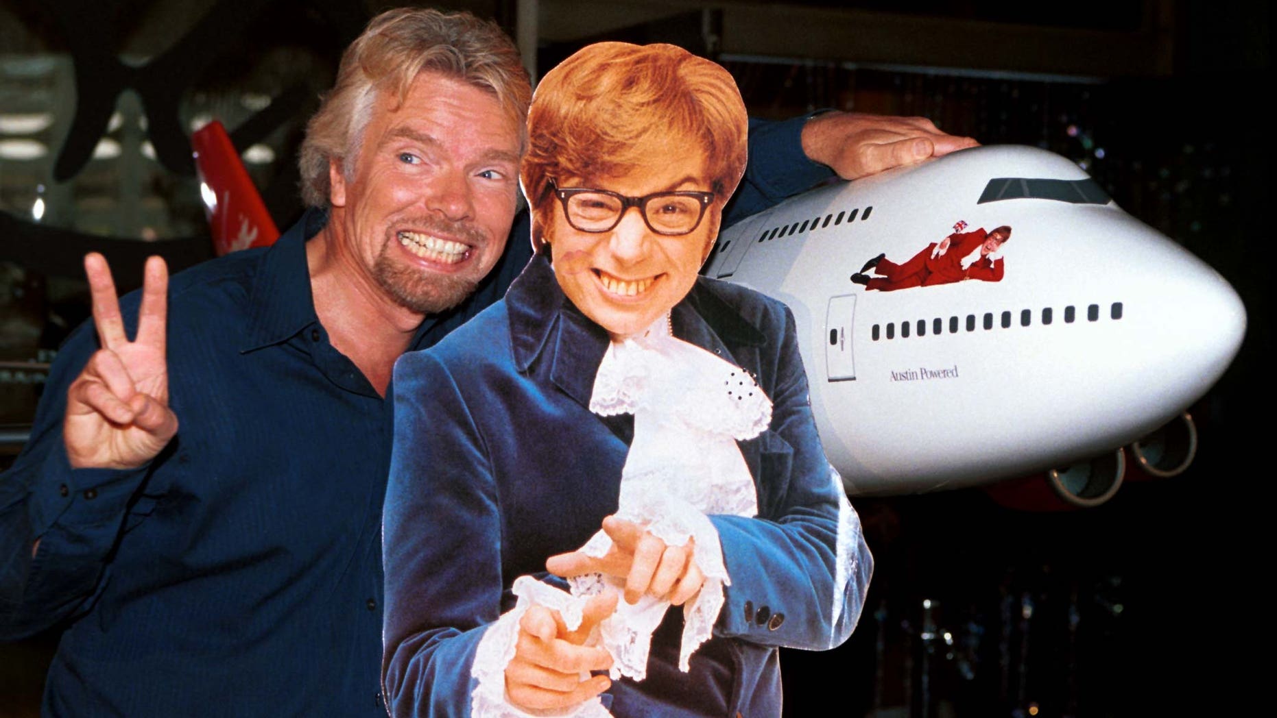 Virgin Atlantic Airways CEO Richard Branson (L) poses with a cut-out of actor Mike Myers, as Austin Powers, after christening ceremonies of Virgin Shaglantic Flight double-O-Seven at Los Angeles International Airport, May 10. The unveiling of the renamed and redecorated airliner signaled the start of a dynamic global air travel marketing blitz in the partnership with the release of the New Line Cinema movie "Austin Powers: The Spy Who Shagged Me".