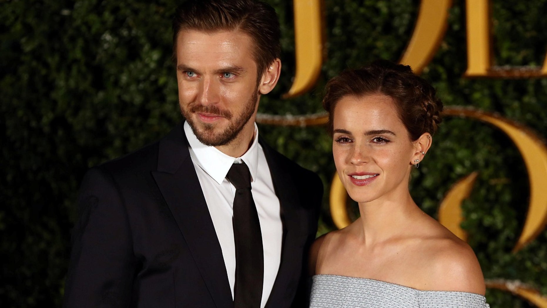 Dan Stevens and Emma Watson pose for photographers at a media event for the live action film "Beauty and the Beast" in London, Britain.