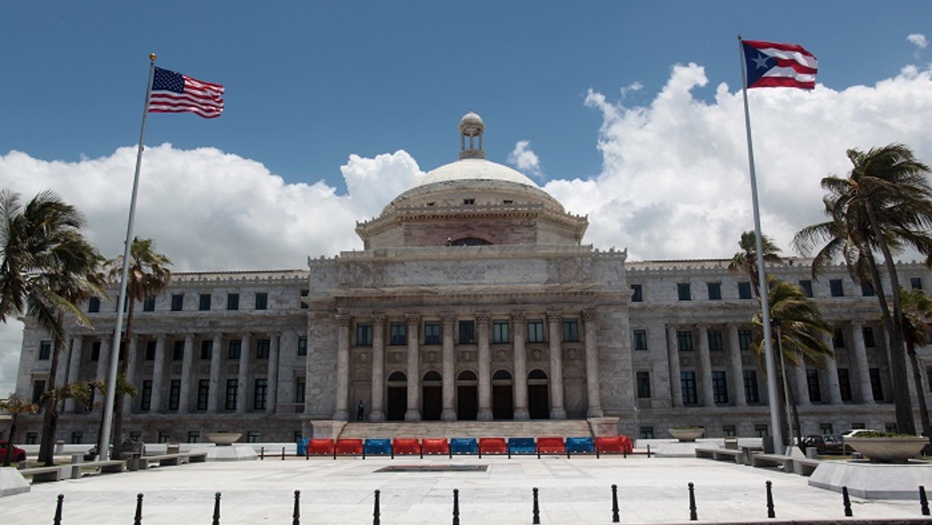 FILE -- The flags of the U.S. and Puerto Rico fly outside the Capitol building in San Juan, Puerto Rico May 4, 2017.