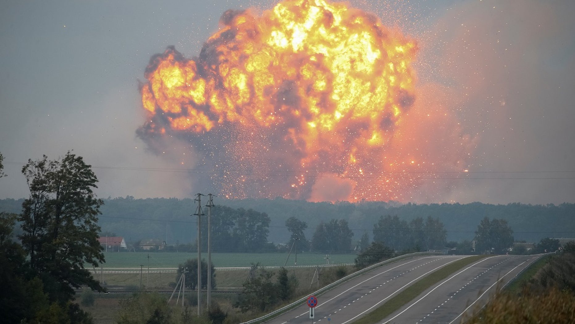 Smoke and flames rise over a warehouse storing ammunition for multiple rocket launcher systems at a military base in the town of Kalynivka.