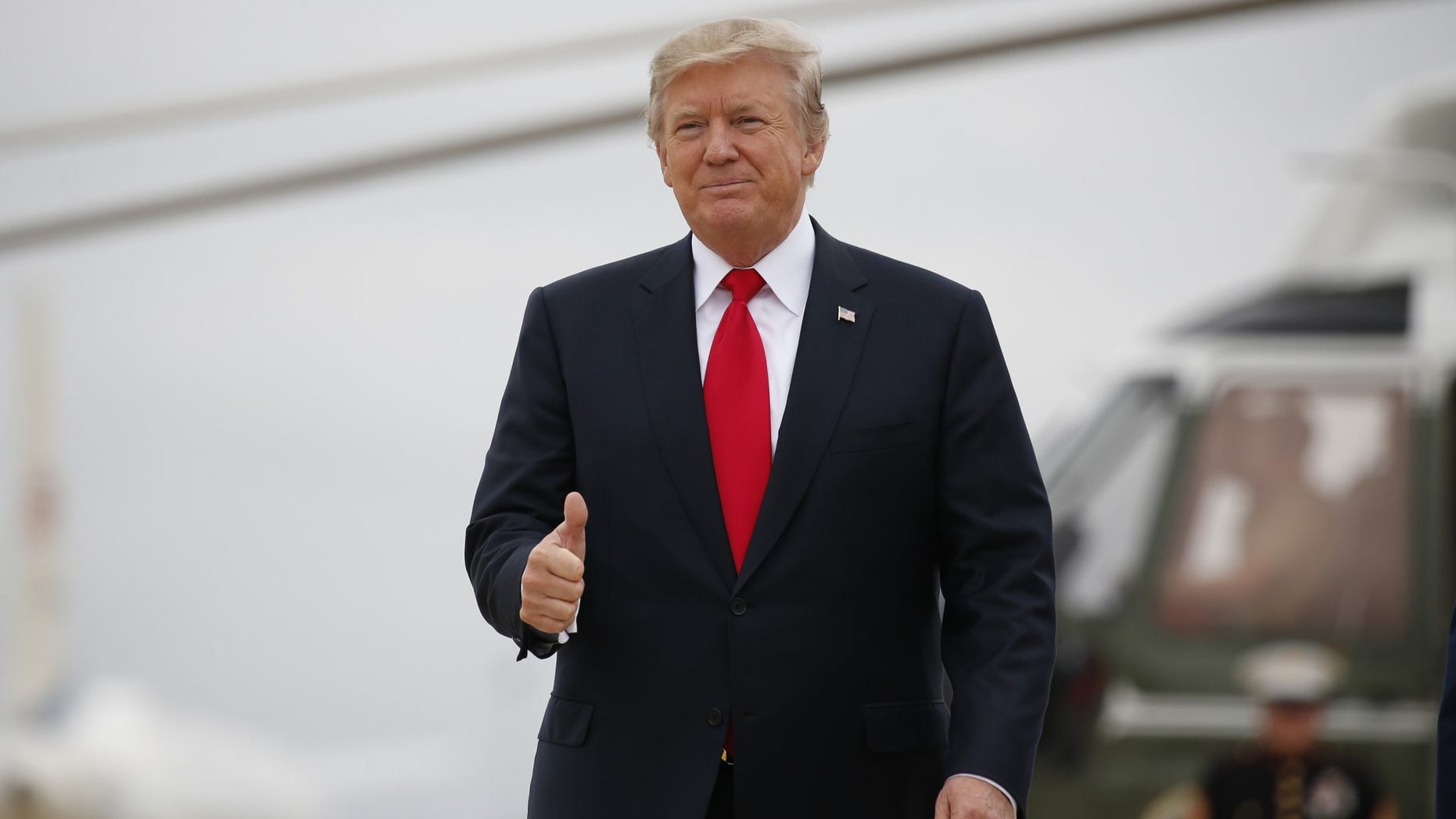 FILE -- President Donald Trump gestures to reporters before departing from Joint Base Andrews, Maryland, in suburban Washington, U.S., October 11, 2017.
