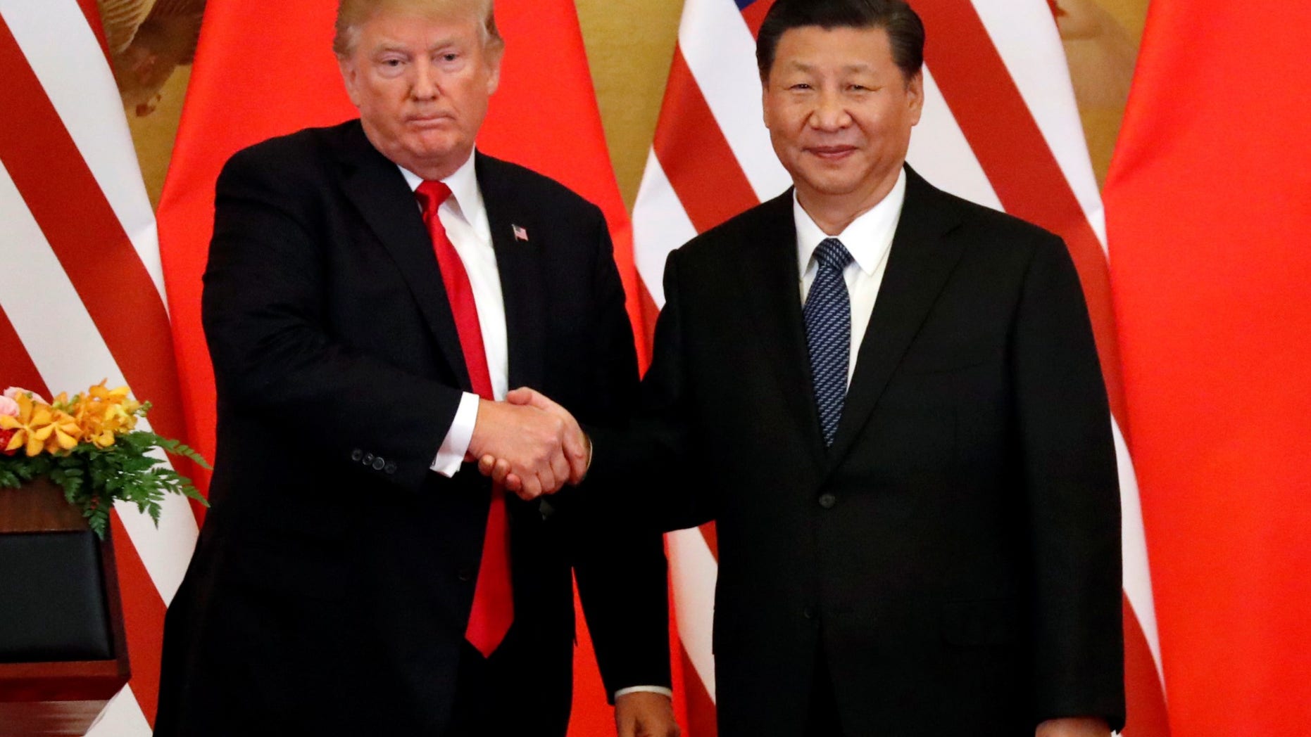 FILE -- President Donald Trump and China's President Xi Jinping make joint statements at the Great Hall of the People in Beijing, China, November 9, 2017.