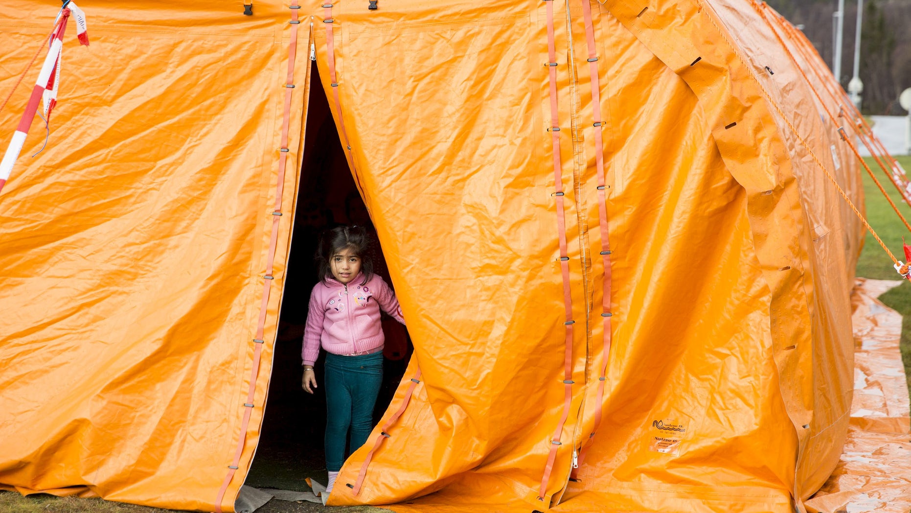 Oct. 13, 2015: A girl looks out from a temporary reception centre at Storskog border station in northern Norway. (Reuters).