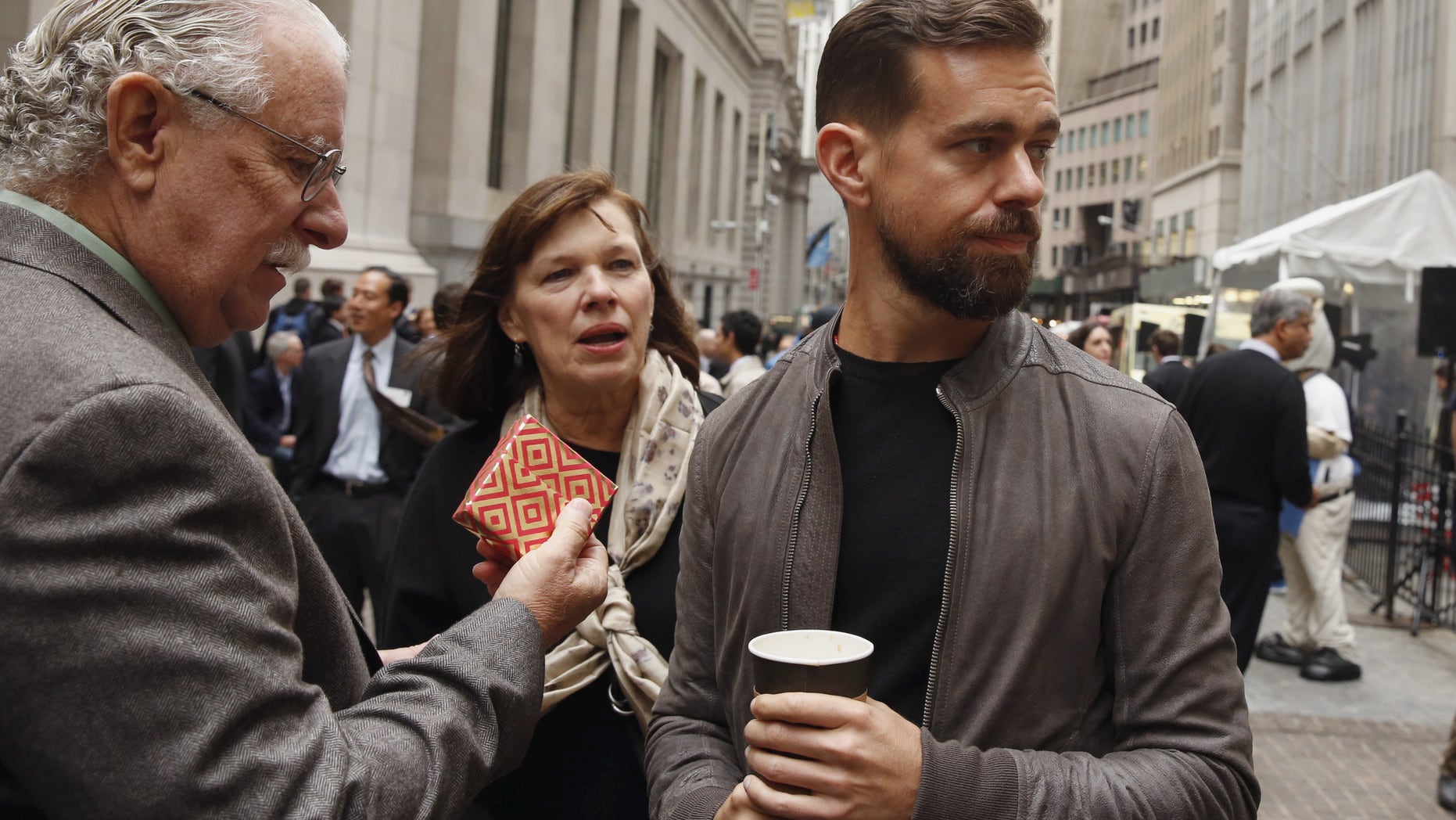 File photo: Jack Dorsey, CEO of Square and CEO of Twitter, stands with his parents Marcia and Tim Dorsey while waiting for an event outside of the New York Stock Exchange to celebrate the IPO of Square Inc., in New York November 19, 2015.