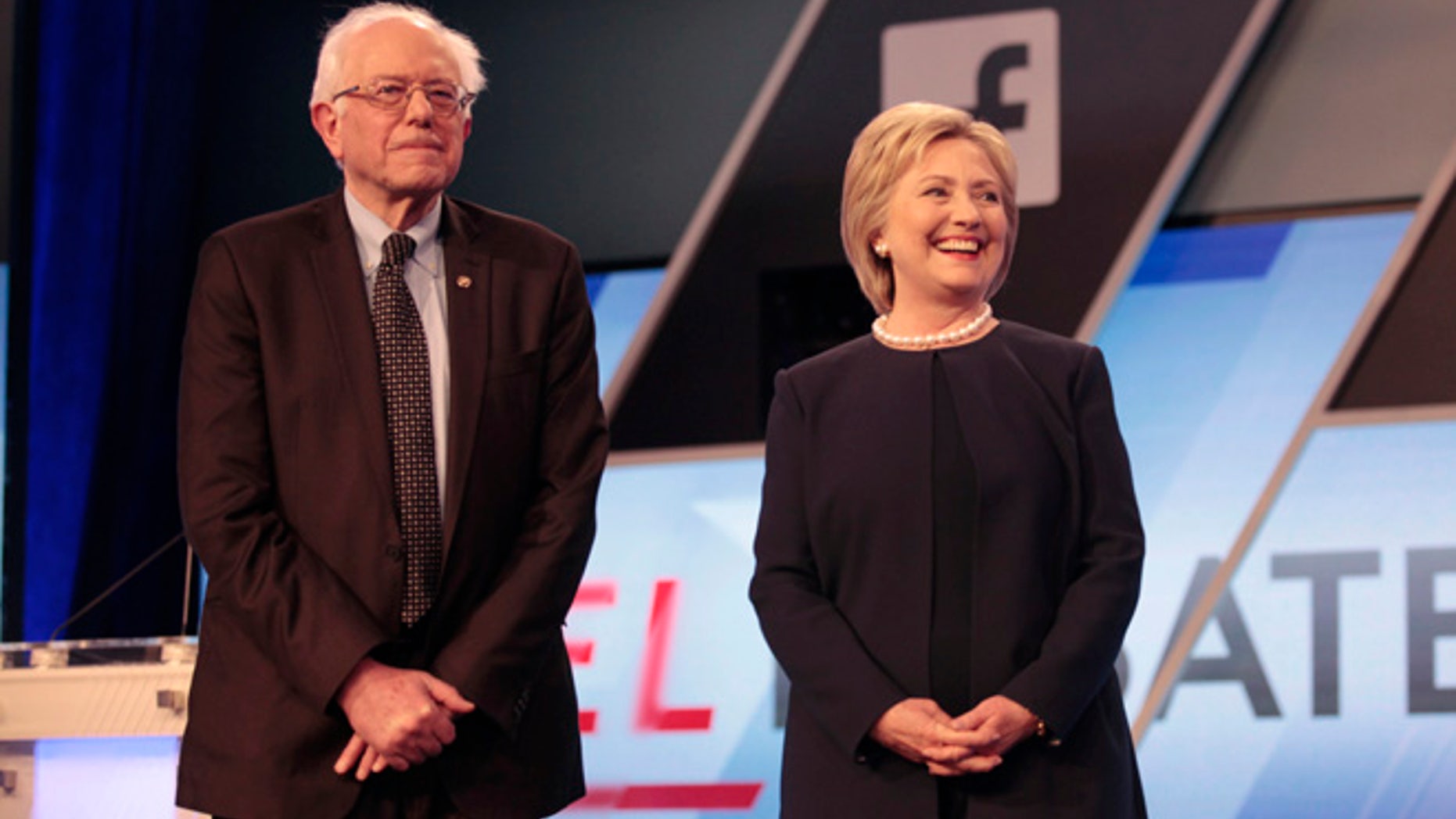 Democratic U.S. presidential candidates Senator Bernie Sanders and Hillary Clinton pose before the start of the Univision News and Washington Post Democratic U.S. presidential candidates debate in Kendall, Florida March 9, 2016. REUTERS/Javier Galeano - RTSA3V8