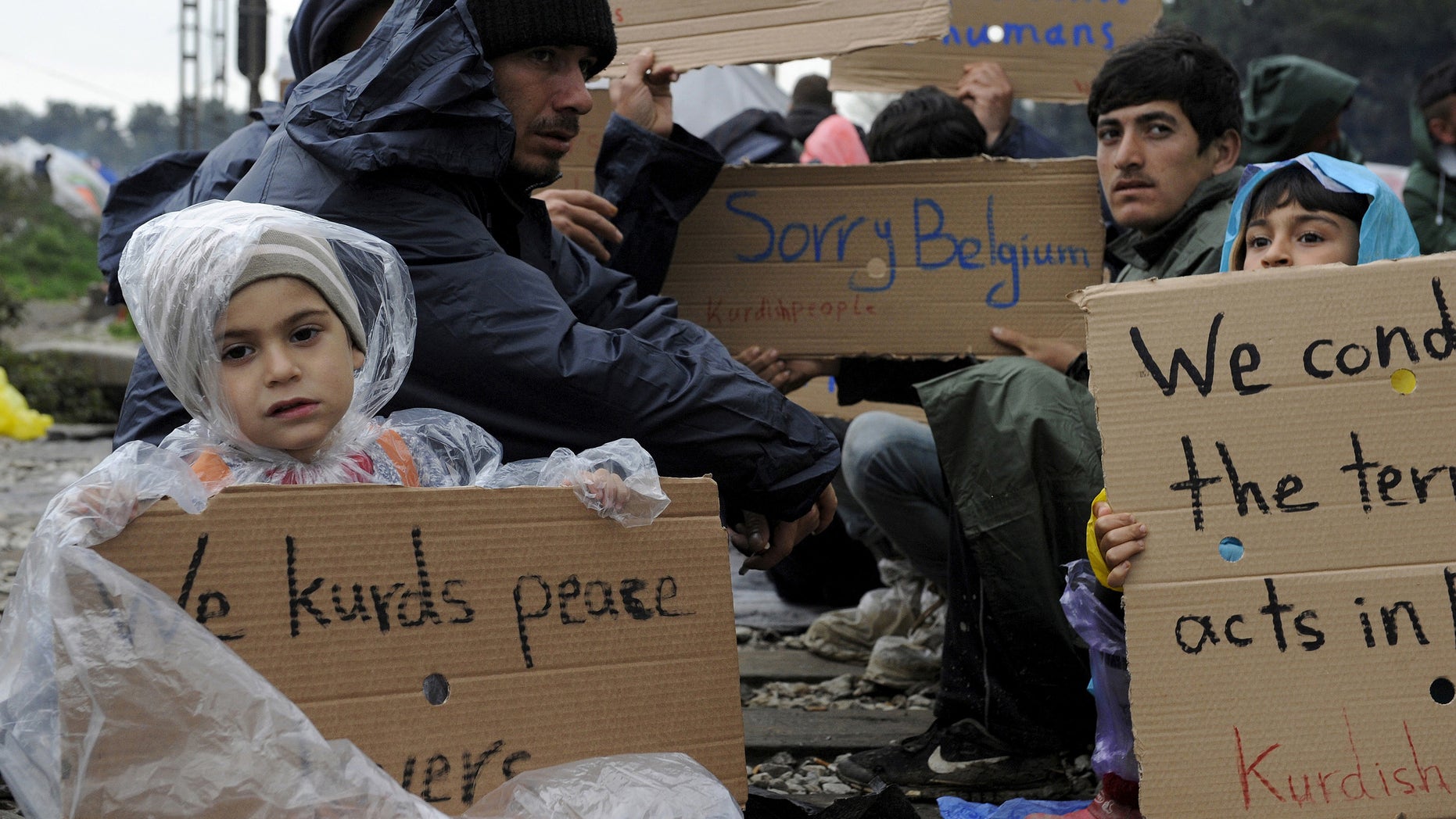 March 23, 2016: Refugees and migrants hold placards during a protest demanding the opening of the Greek-Macedonian border. (Reuters)