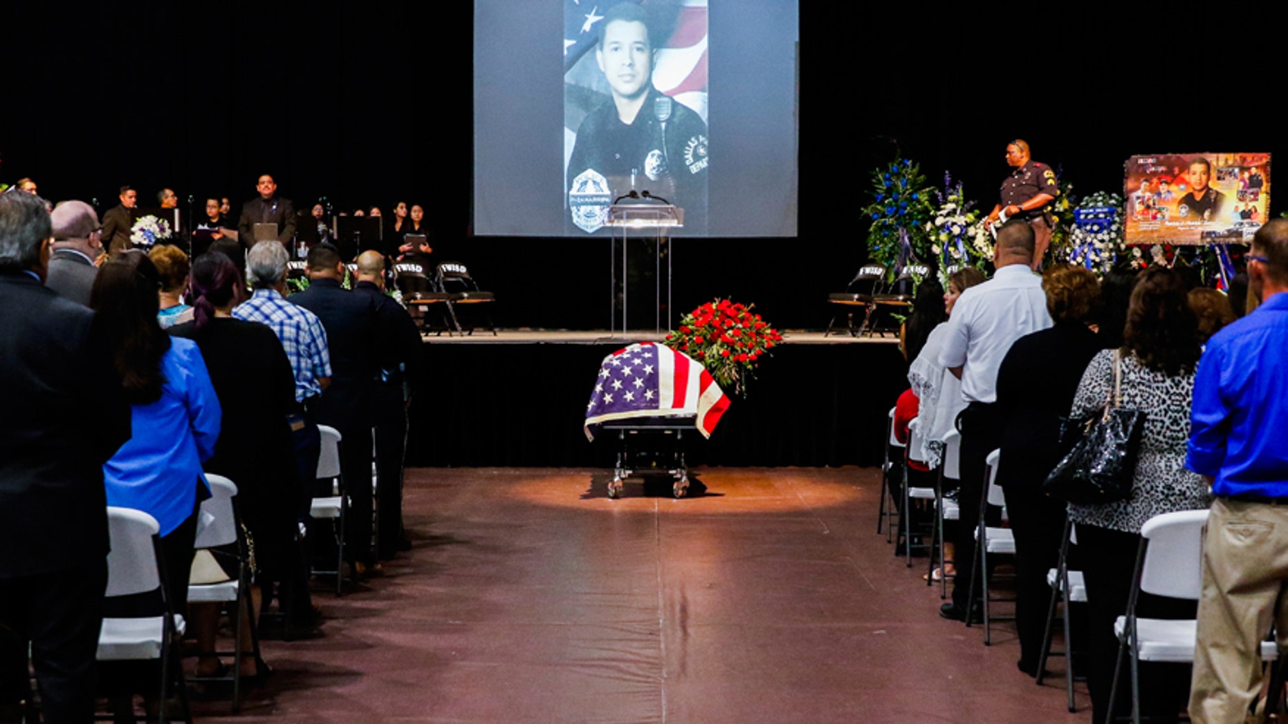Mourners attend the funeral service for Dallas police officer Patrick Zamarripa, a former U.S. Navy veteran, who was among five police officers shot dead the previous week, in Fort Worth, Texas, U.S. July 16, 2016. REUTERS/Ashley Landis/The Dallas Morning News/Pool - RTSIBU6