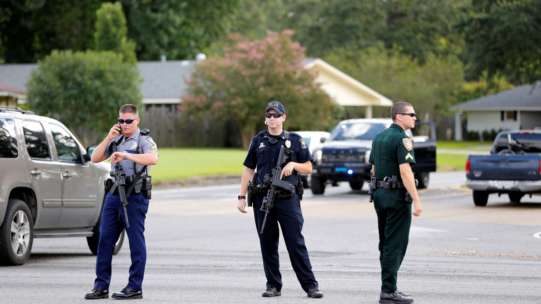 Police officers block off a road after a shooting of police in Baton Rouge, Louisiana, U.S. July 17, 2016. REUTERS/Joe Penney - RTSIE5M