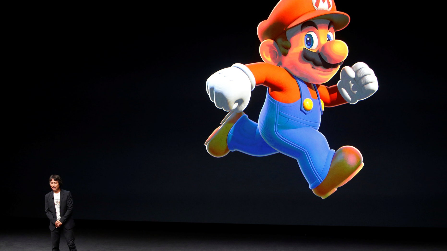 Nintendo Creative Fellow Shigeru Miyamoto stands next to the Super Mario character during an Apple media event in San Francisco, California, U.S. September 7, 2016. (REUTERS/Beck Diefenbach/File Photo)