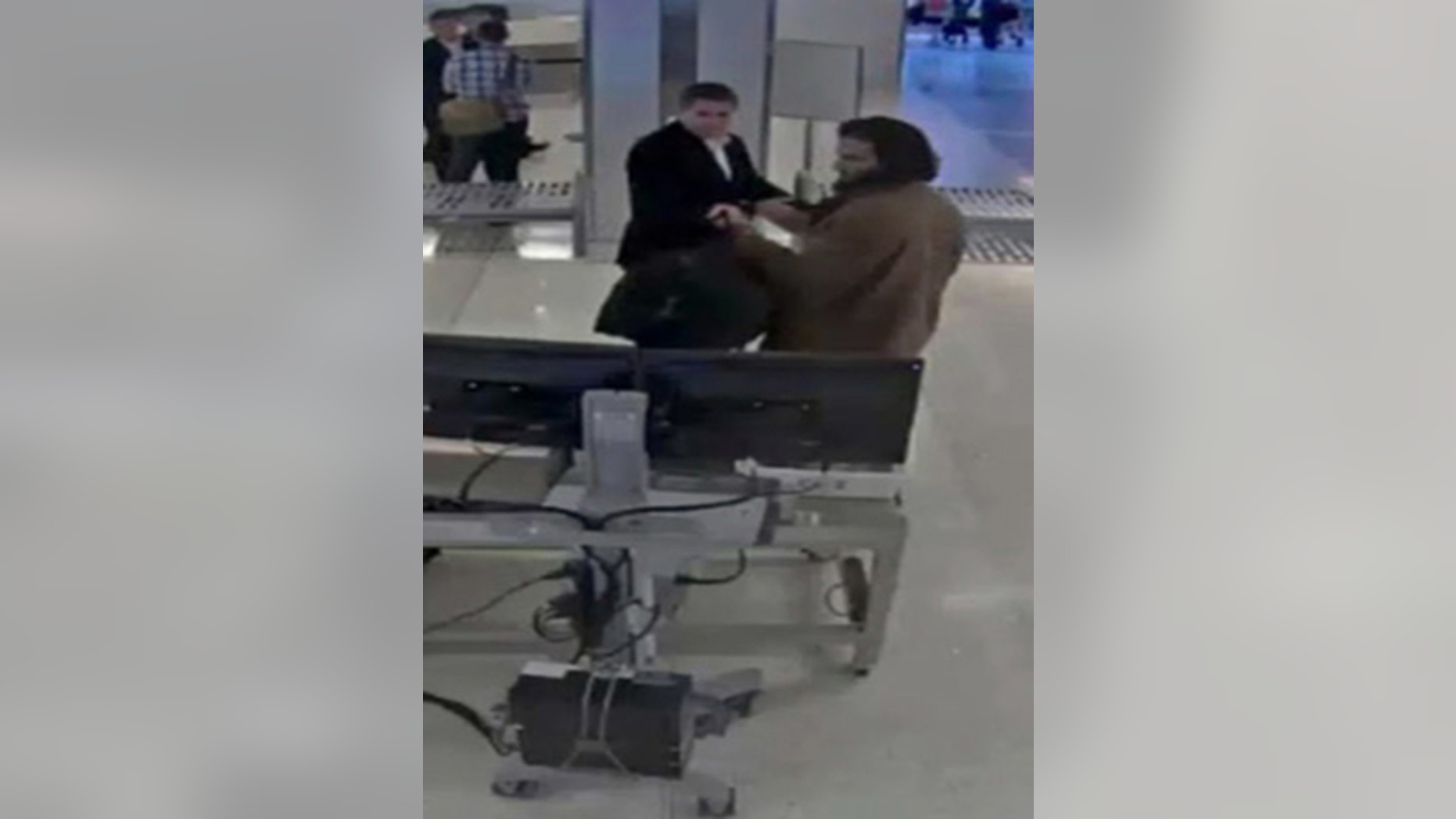Nader Elhuzayel is pictured going through security at LAX on May 21, 2015.