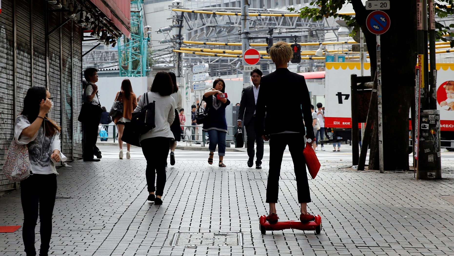 A man rides a hoverboard in Tokyo, Japan, September 29, 2016. (REUTERS/Toru Hanai)