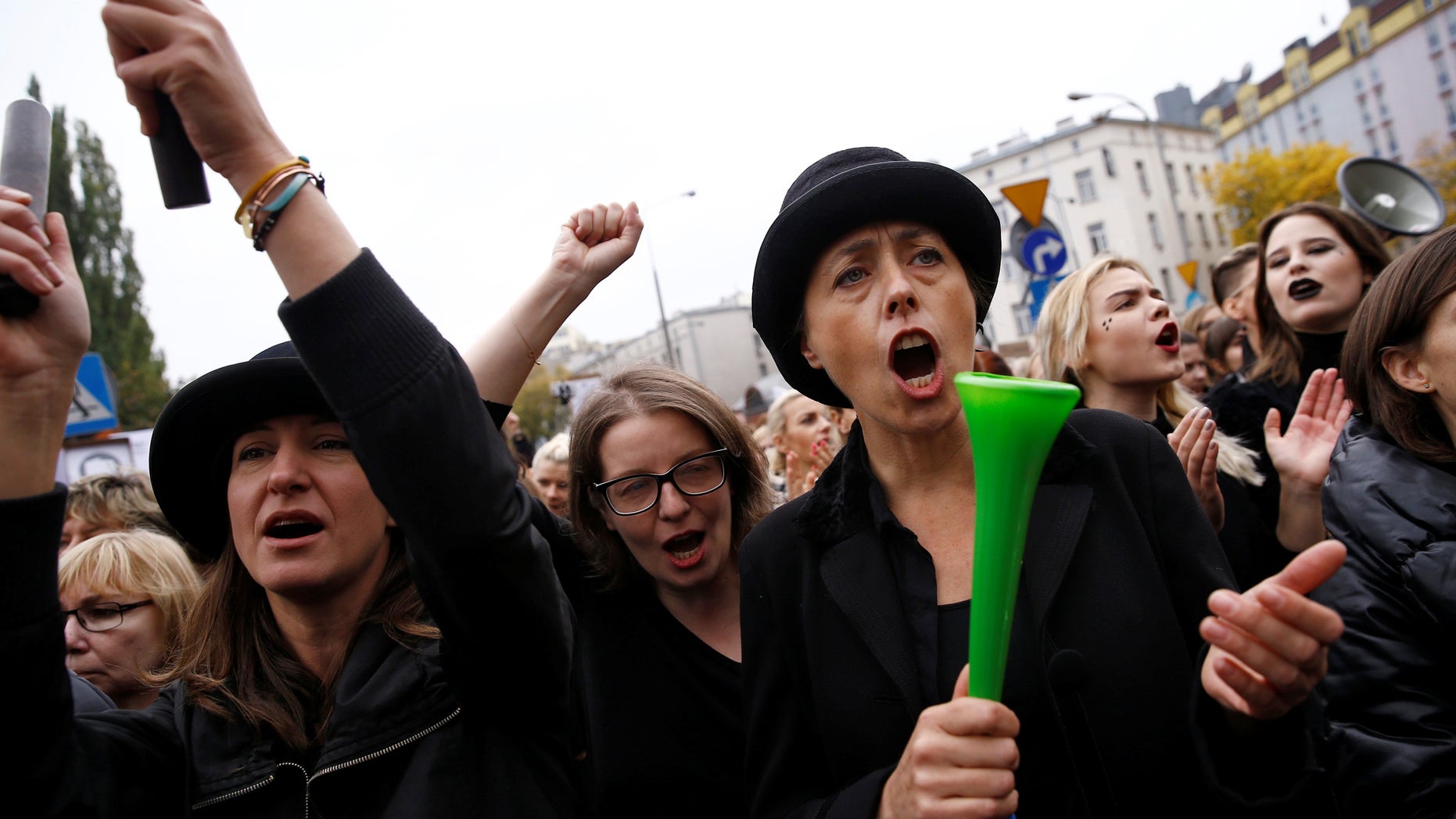 Women shout slogans as they protest a proposed ban on abortion in Poland.