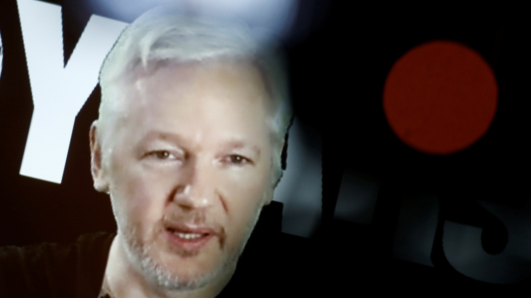 Julian Assange, Founder and Editor-in-Chief of WikiLeaks speaks via video link during a press conference on the occasion of the ten year anniversary celebration of WikiLeaks in Berlin, Germany, October 4, 2016. (REUTERS/Axel Schmidt)