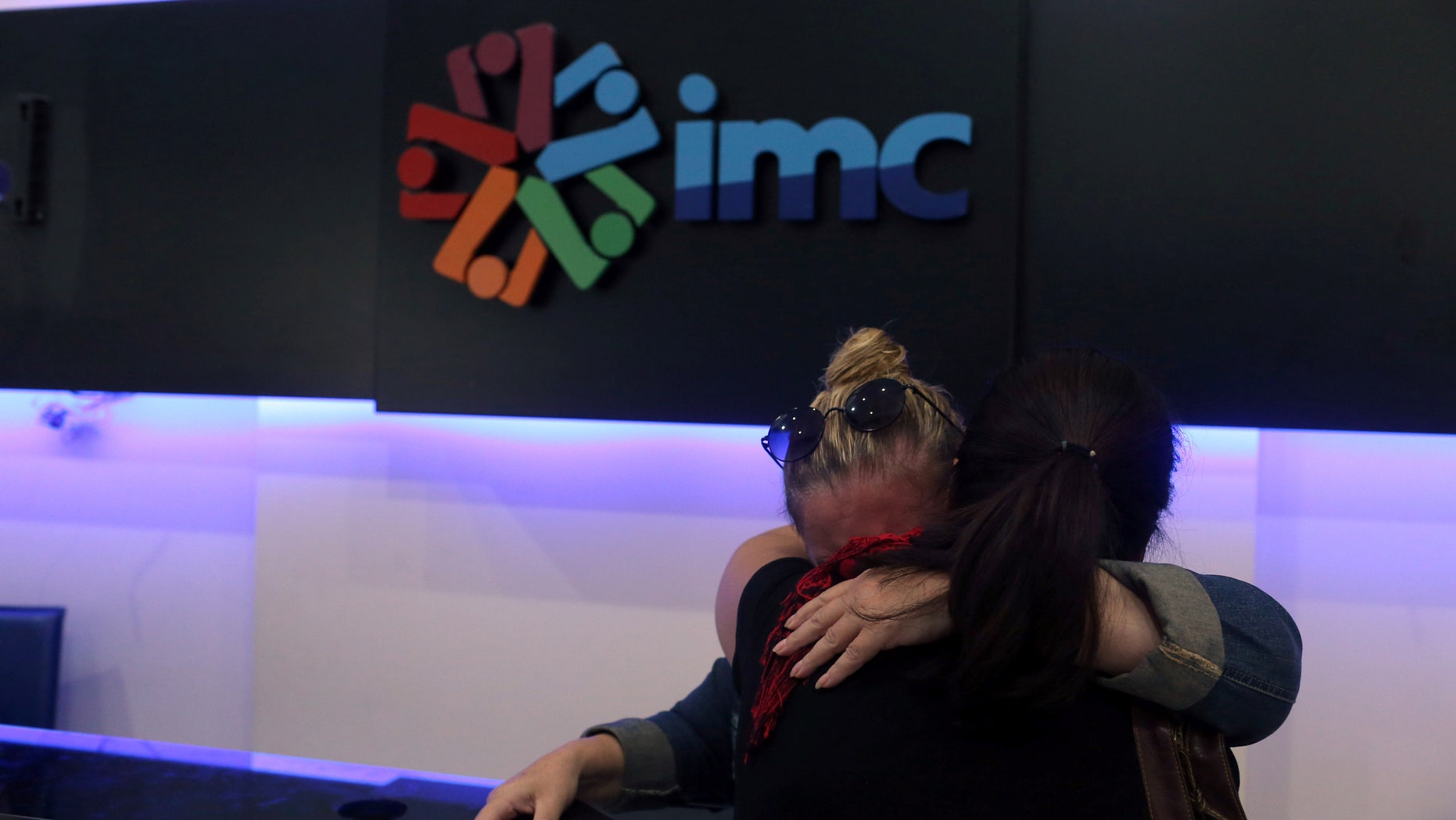 IMC TV employees react Tuesday after their broadcaster's transmission was cut.