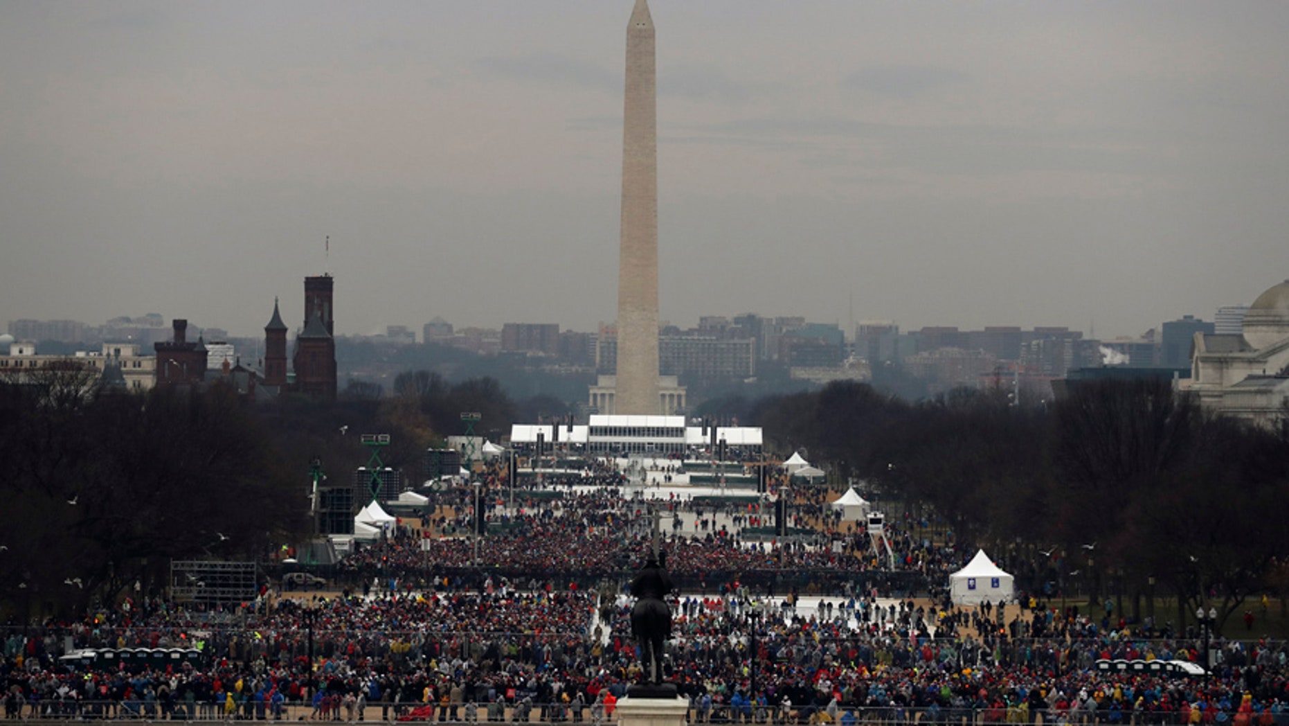 The statue of Civil War General and former US President Ulysses S. Grant faces the Washington Monument and the crowd gathering for the inauguration ceremonies to swear in Donald Trump as the 45th president of the United States at the U.S. Capitol in Washington, U.S., January 20, 2017. REUTERS/Carlos Barria - RTSWGVS