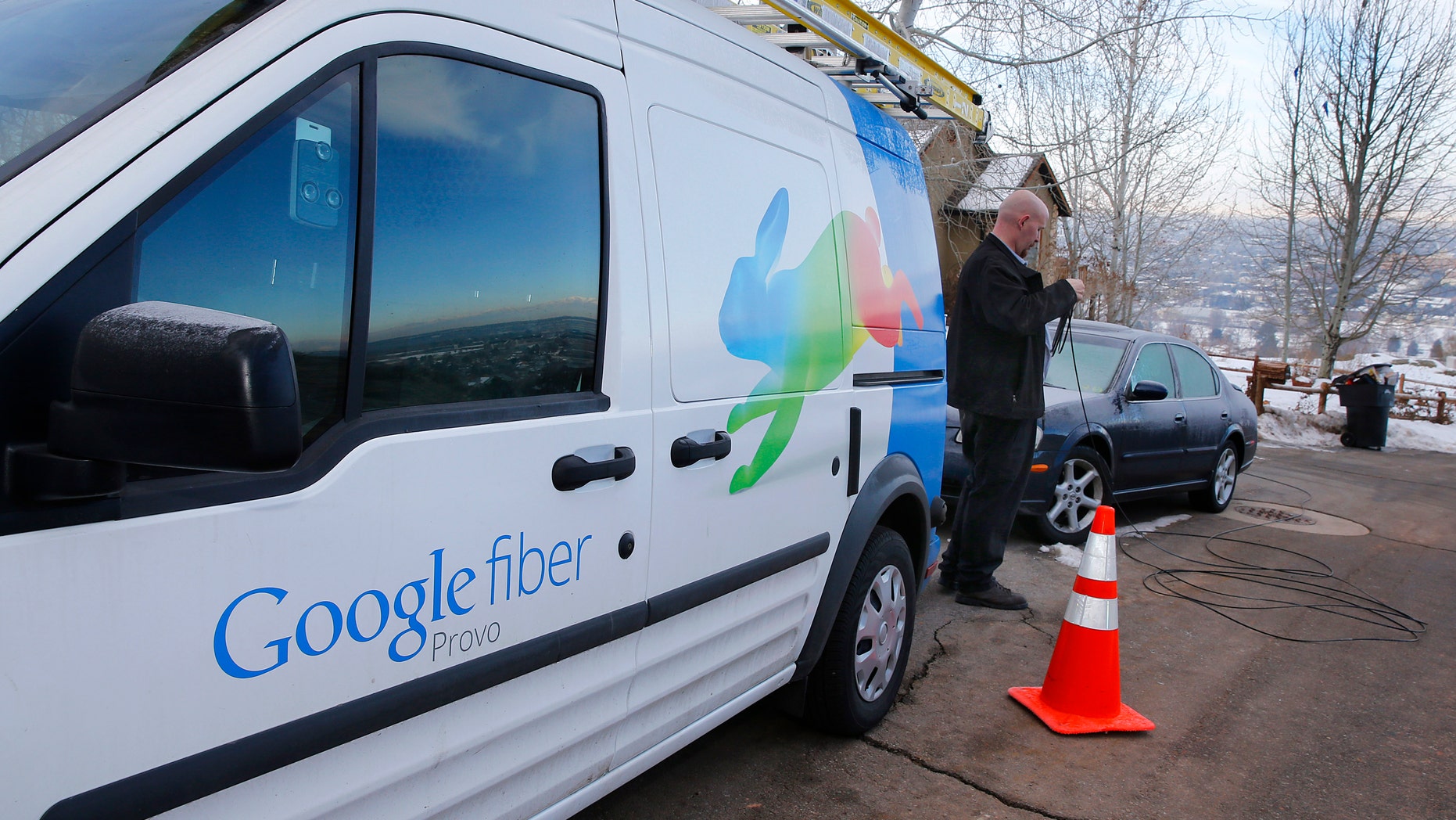 File photo: A technician gets cabling out of his truck to install Google Fiber in a residential home in Provo, Utah, January 2, 2014.