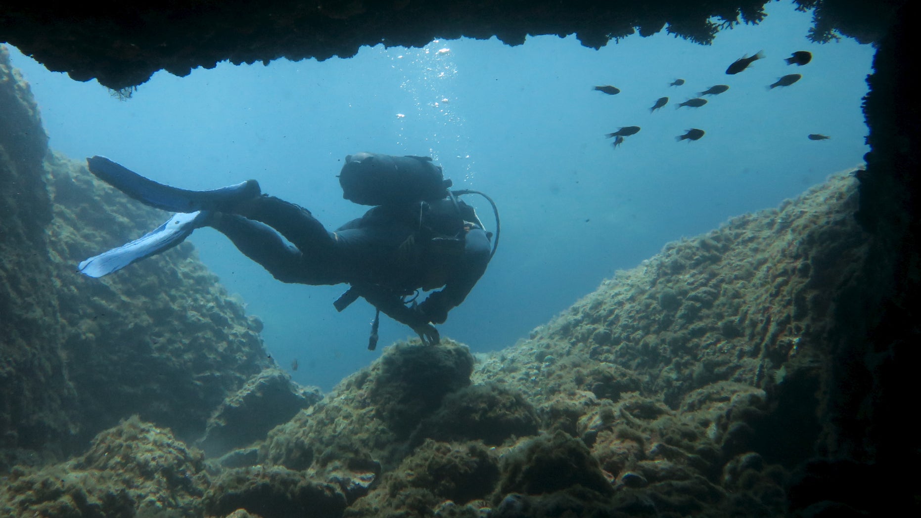 File photo: A scuba diver makes his way out from from an underwater passageway at Isola Bella in Taormina, Italy, at the start of summer holiday season on the Mediterranean island of Sicily July 5, 2015. (REUTERS/John Schults)