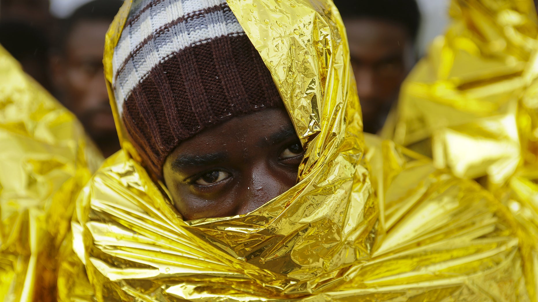 A migrant waits to disembark from a Coast Guard ship in the Sicilian harbour of Messina, Italy August 4, 2015. REUTERS/Antonio Parrinello