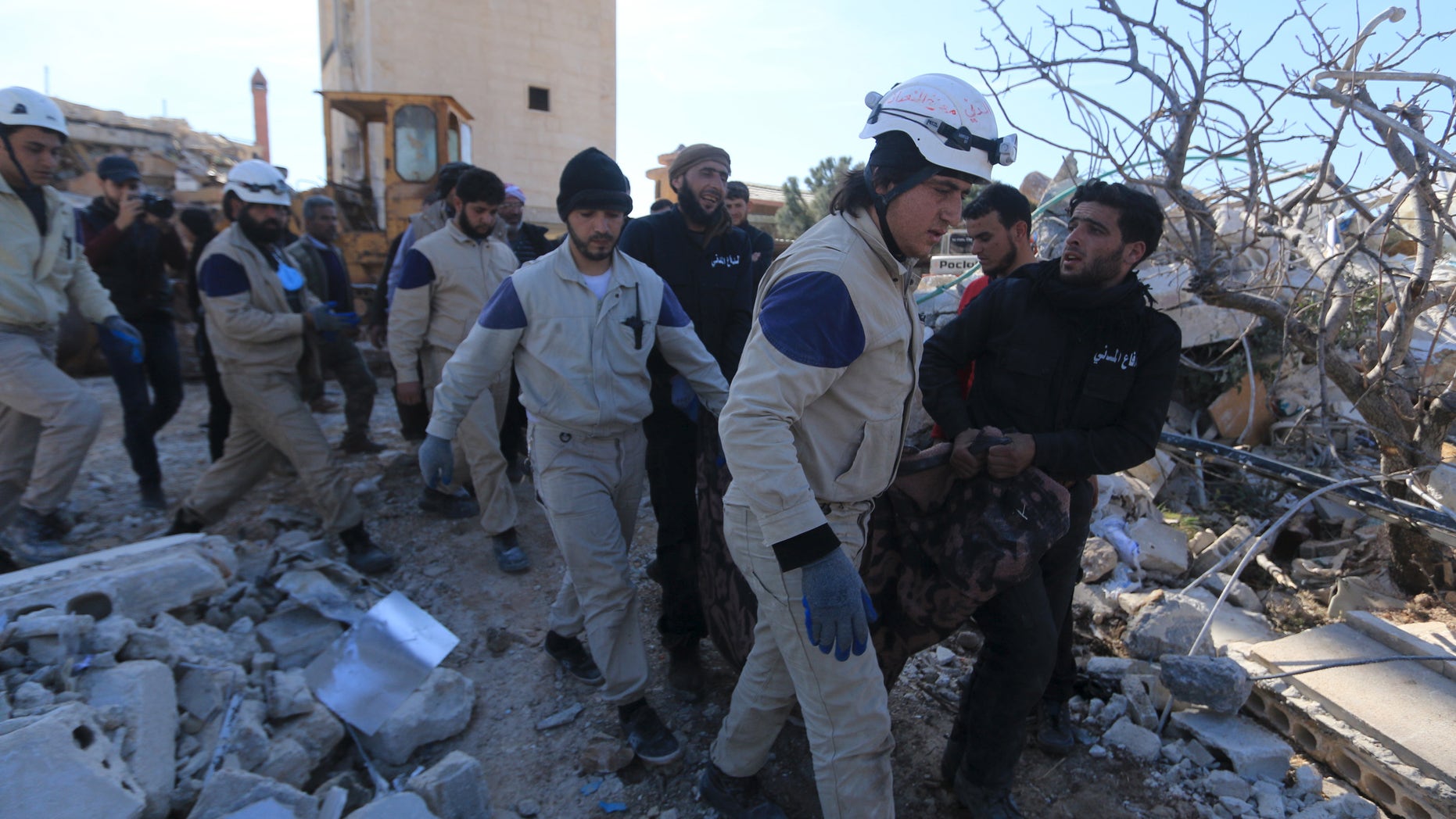 Feb 16., 2016: People and Civil Defense members carry a victim from a destroyed Doctors Without Borders hospital in Syria. (Reuters)