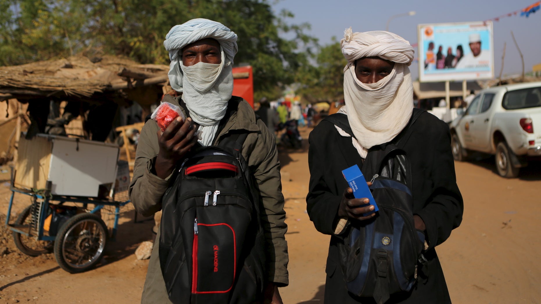 Two young Fulani men selling phones.