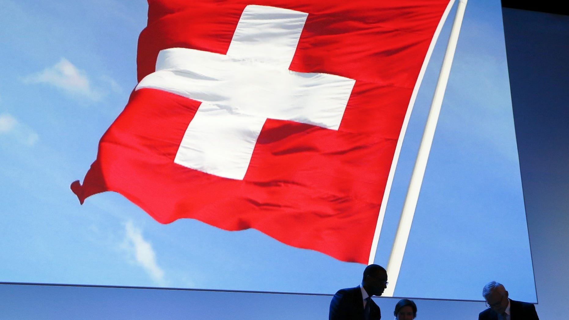 FILE -- Switzerland's national flag is seen in the background.