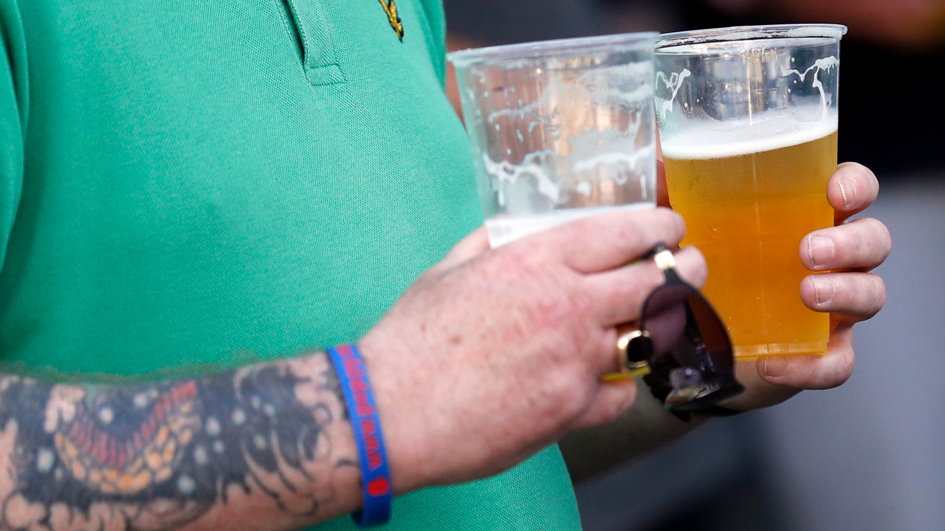 An England supporter carries beer shortly before a drinking ban comes into effect in Lille, France, June 14, 2016.