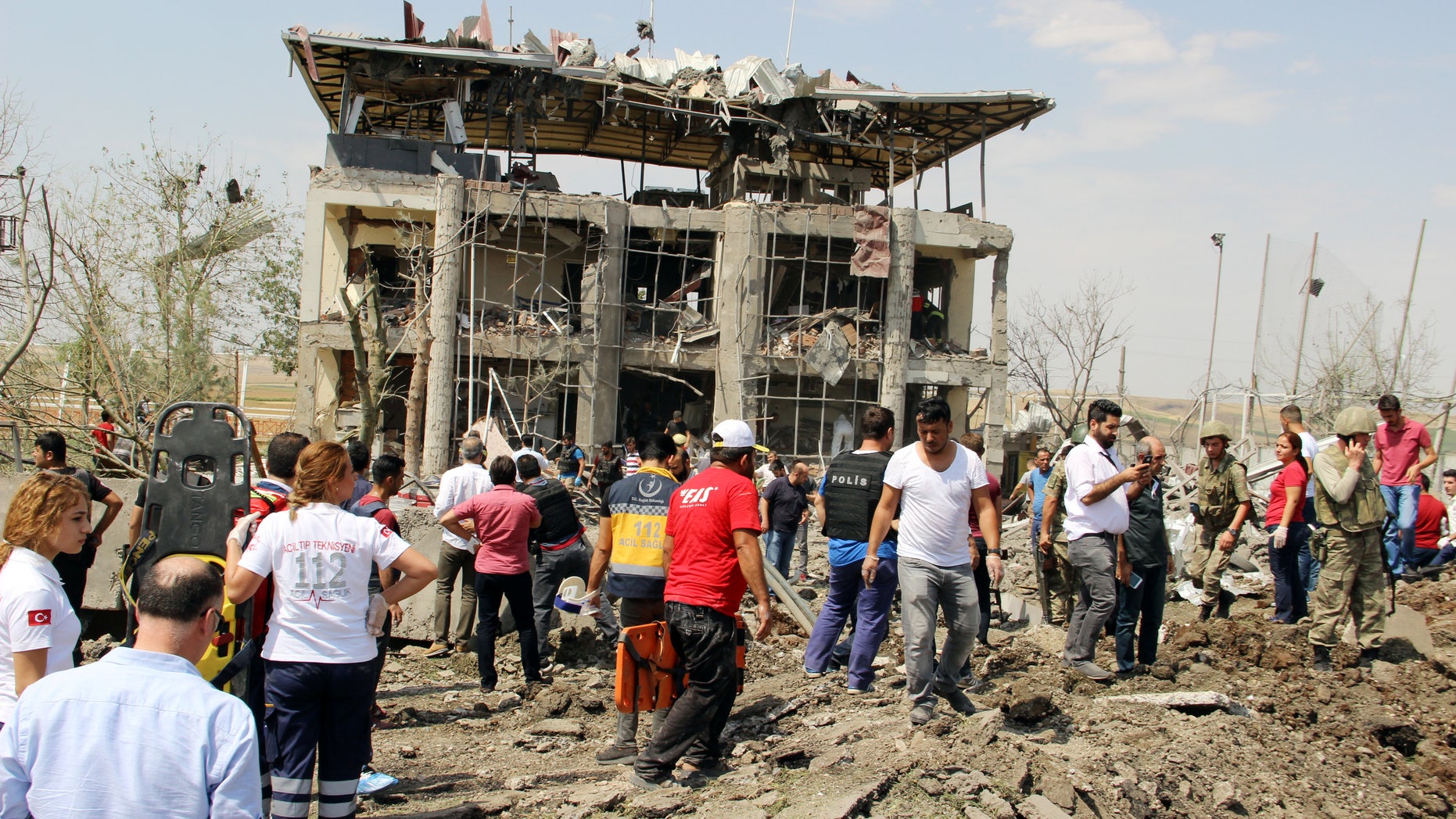 Soldiers, medics, rescue teams and officials work at the blast scene.