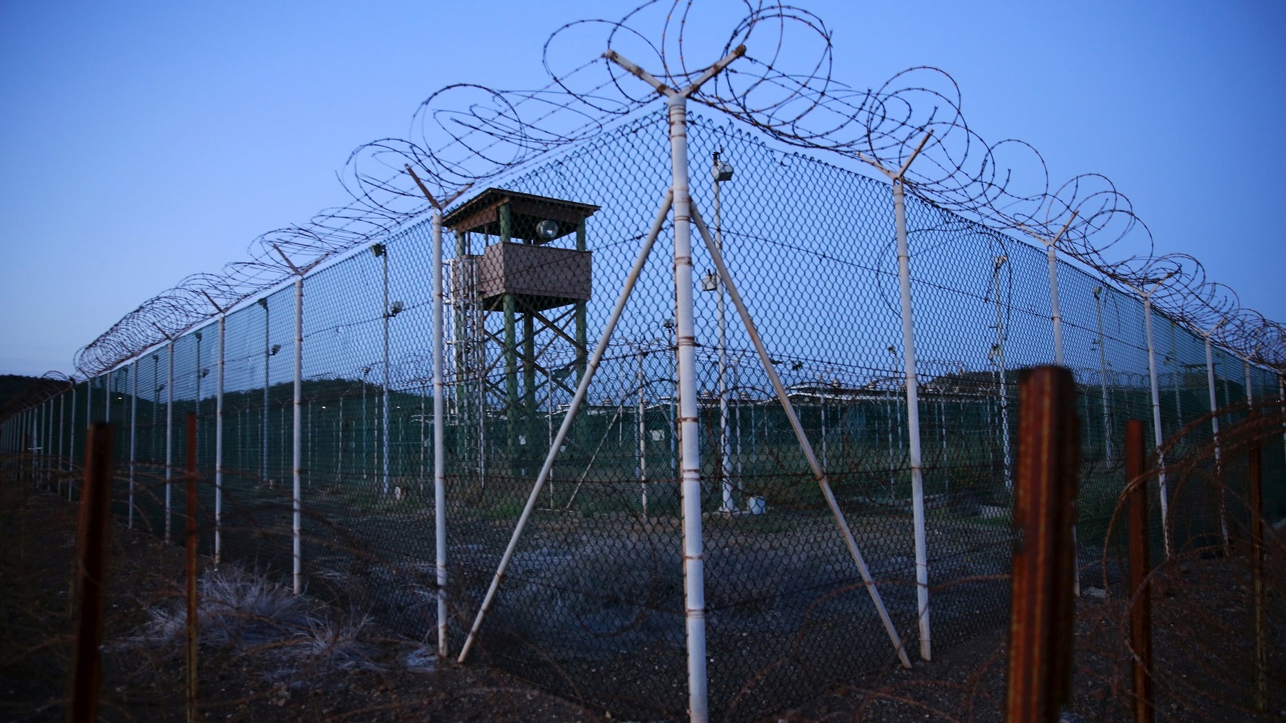 FILE PHOTO - Chain link fence and concertina wire surrounds a deserted guard tower within Joint Task Force Guantanamo's Camp Delta at the U.S. Naval Base in Guantanamo Bay, Cuba March 21, 2016. REUTERS/Lucas Jackson/File Photo TPX IMAGES OF THE DAY - S1AETVRIXQAA