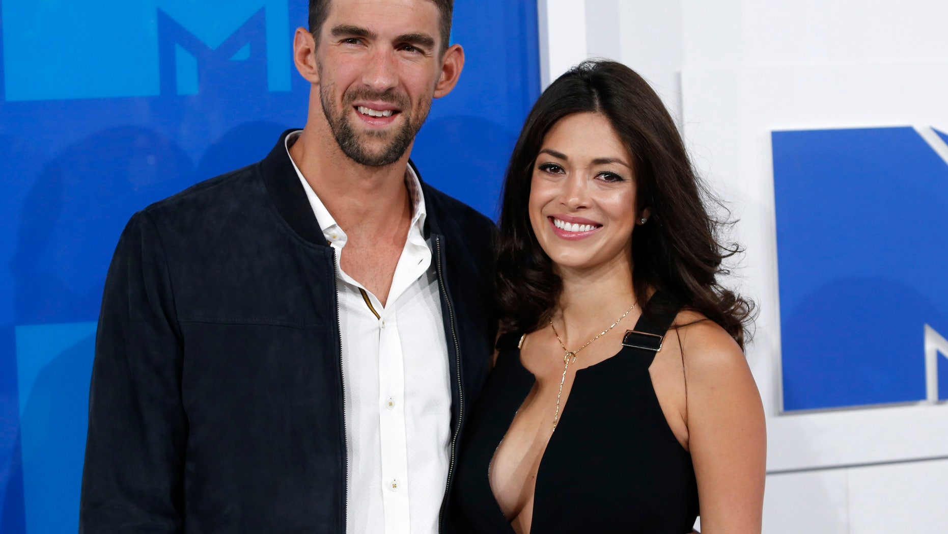 Olympic swimmer Michael Phelps and fiancee Nicole Johnson arrive at the 2016 MTV Video Music Awards in New York, U.S., August 28, 2016.