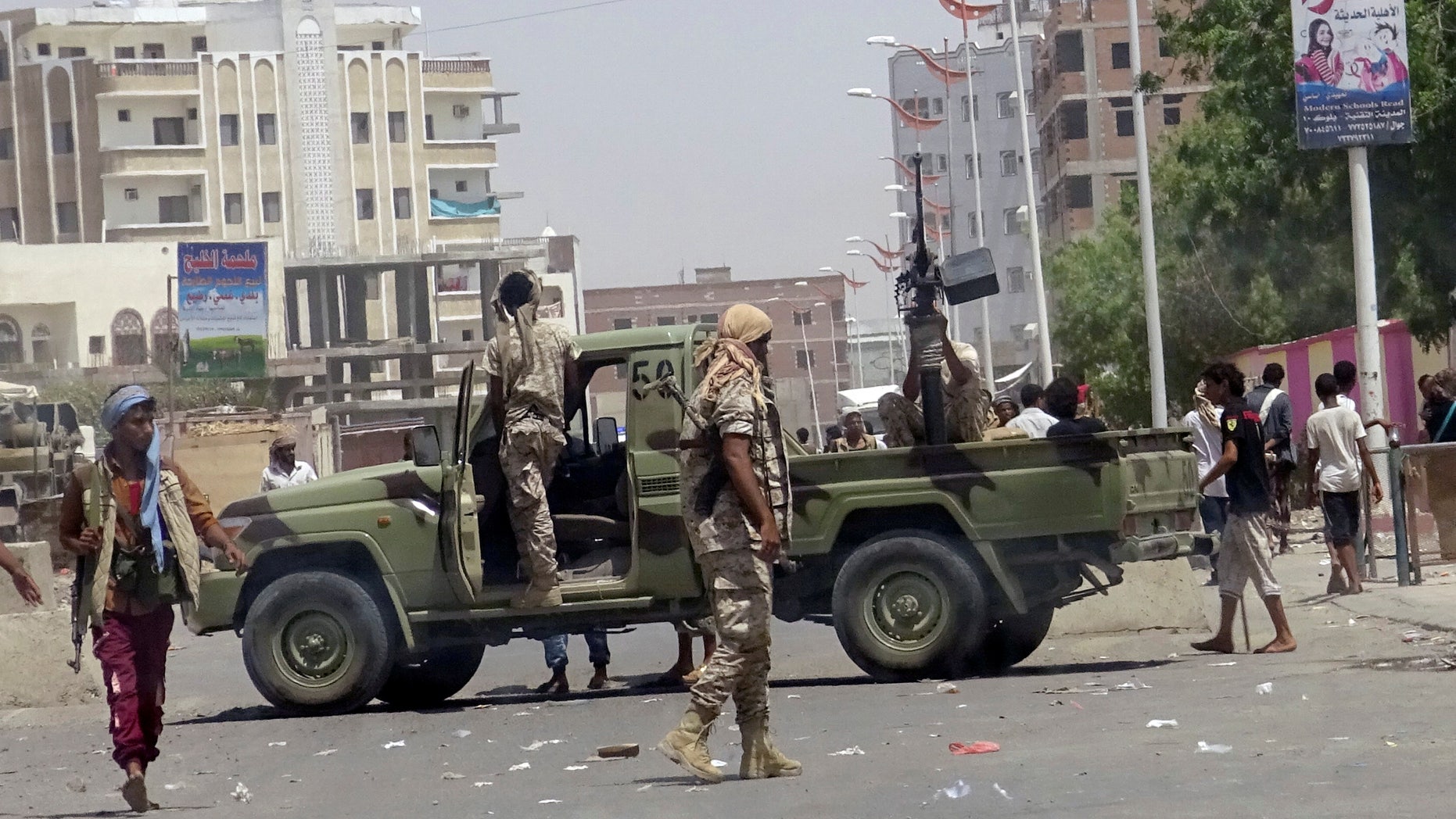 Soldiers and onlookers at the site of the suicide attack in Aden.