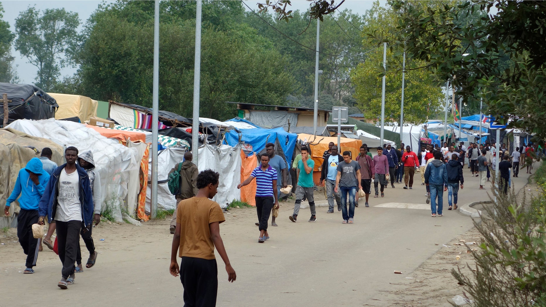 Sept. 6, 2016: Migrants walk in the northern area of the camp called the "Jungle" in Calais, France.