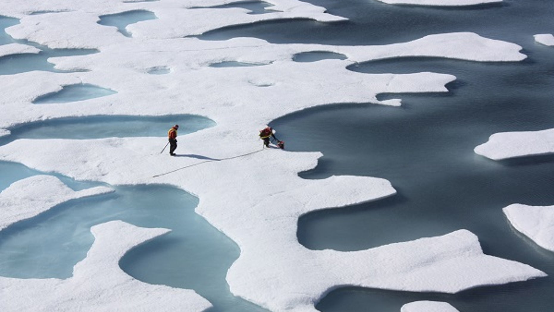 The crew of the U.S. Coast Guard Cutter Healy, in the midst of their ICESCAPE mission, retrieves supplies in the Arctic Ocean in this July 12, 2011 NASA handout photo. Kathryn Hansen/NASA via REUTERS/File Photo ATTENTION EDITORS - THIS IMAGE WAS PROVIDED BY A THIRD PARTY. EDITORIAL USE ONLY. - RTX2RRXI