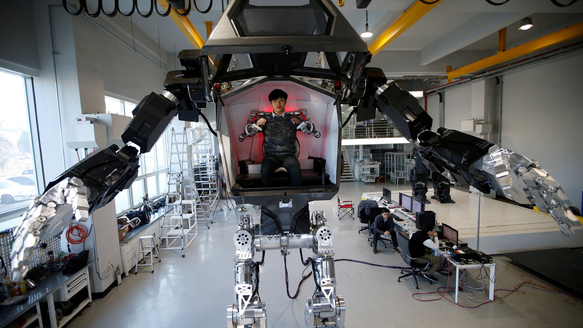 An employee controls the arms of a manned biped walking robot "METHOD-2" during a demonstration in Gunpo, South Korea, December 27, 2016. (REUTERS/Kim Hong-Ji)