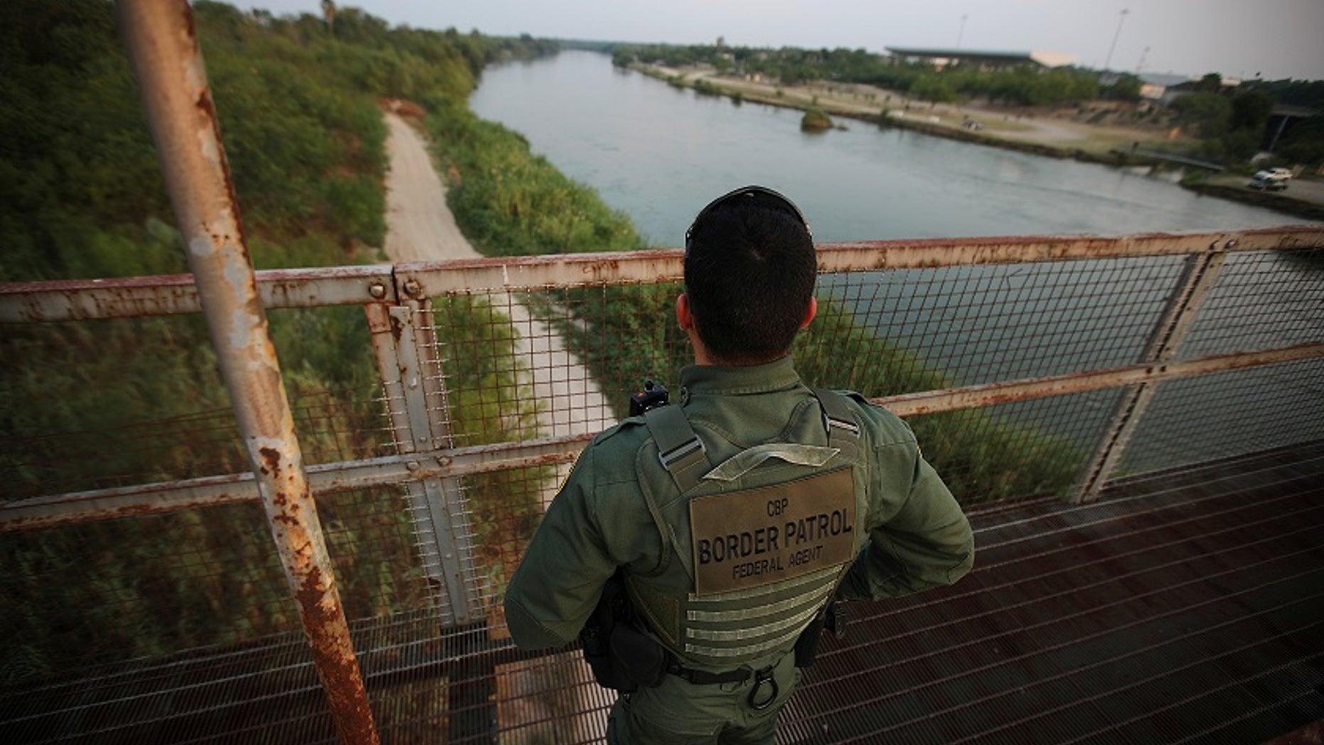 May 11, 2017: A U.S. border patrol agent looks over the Rio Grande river at the border between United States and Mexico.