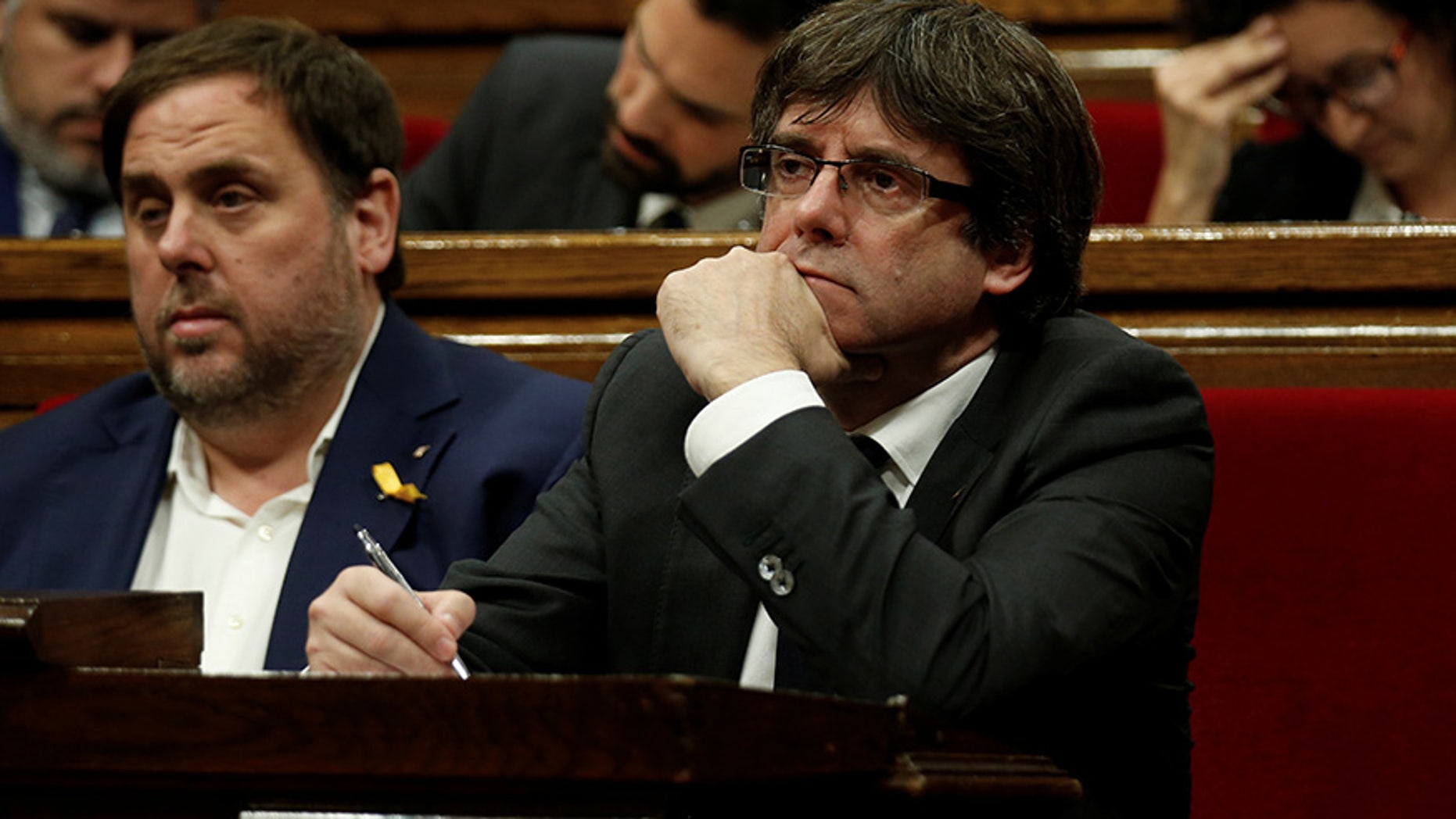 Catalan President Carles Puigdemont (R) and Vice President Oriol Junqueras attend a session at the Catalan regional Parliament in Barcelona, Spain, October 26, 2017. REUTERS/Albert Gea - RC1E8FE5B410