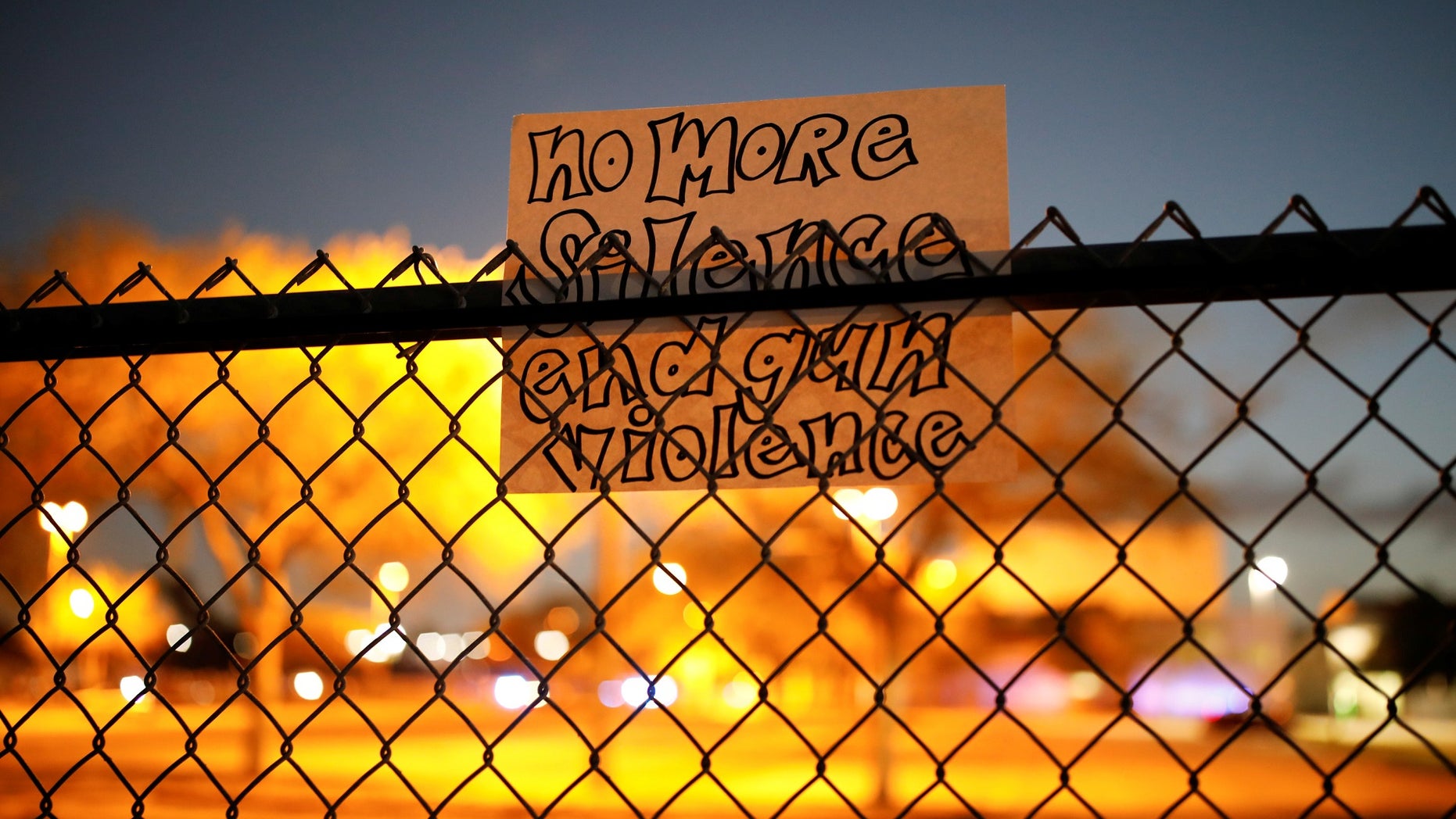A note is seen on the fence of the Marjory Stoneman Douglas High School following the mass shooting, in Parkland, Florida.