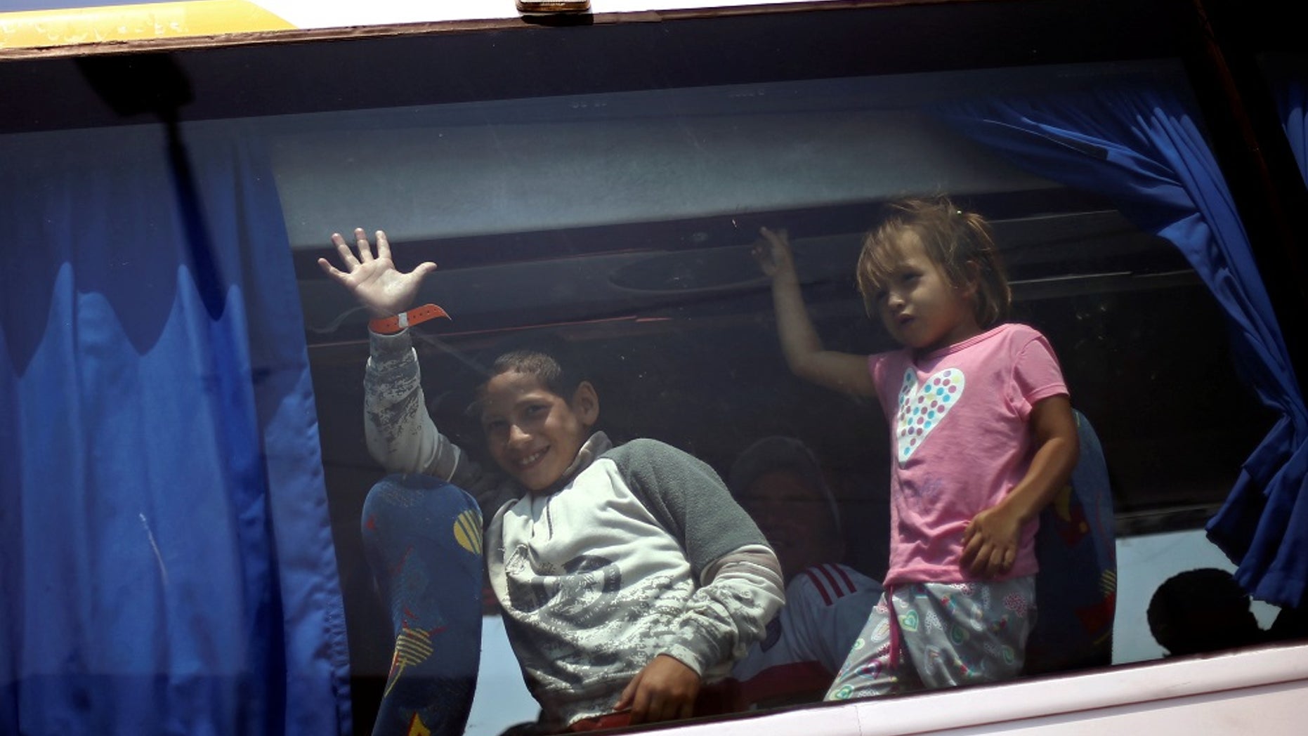 Migrant children from Central America arrive in a caravan at a temporary shelter set up for them by the Roman Catholic church, in Mexico City, April 9, 2018.