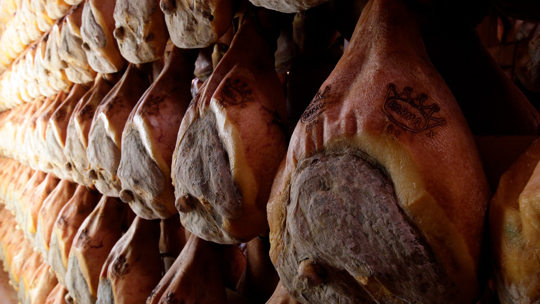 A line of hams hang to dry. (Reuters)