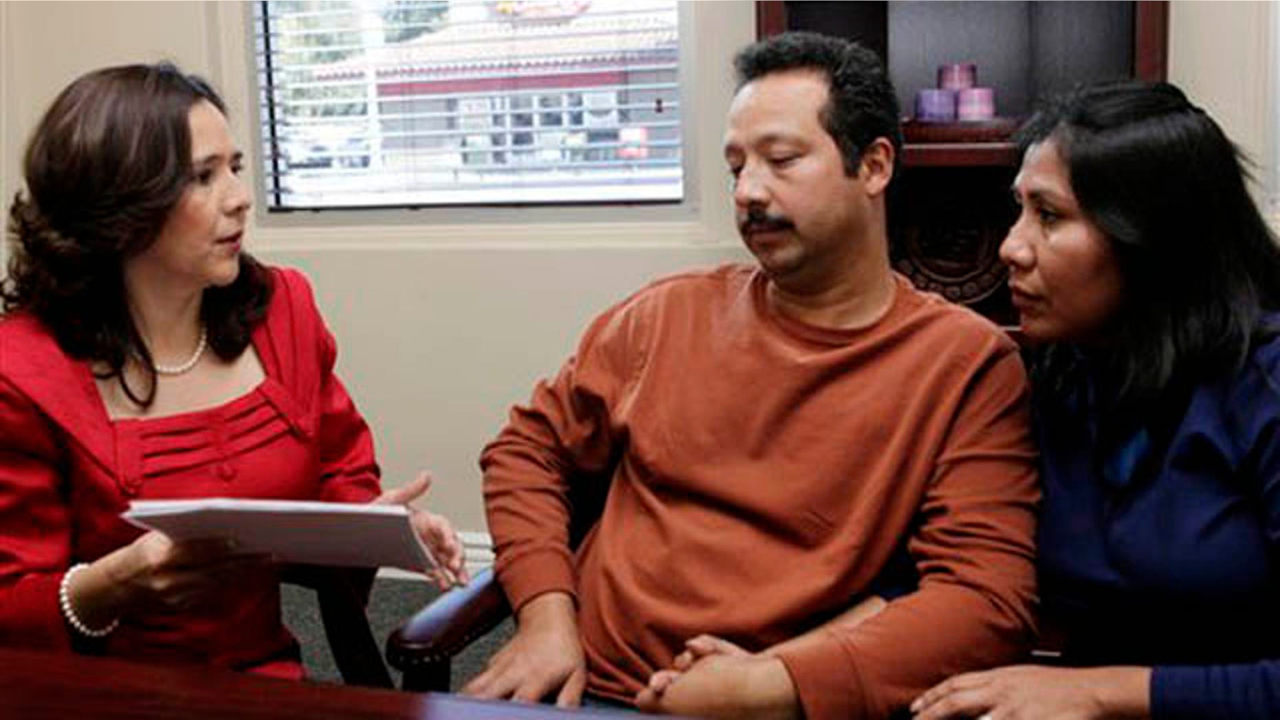 Jan. 6, 2012: Attorney Jessica Dominguez, left speaks with Jose Luis Barajas and his wife, Laura Barajas at Dominguez' office in Los Angeles.