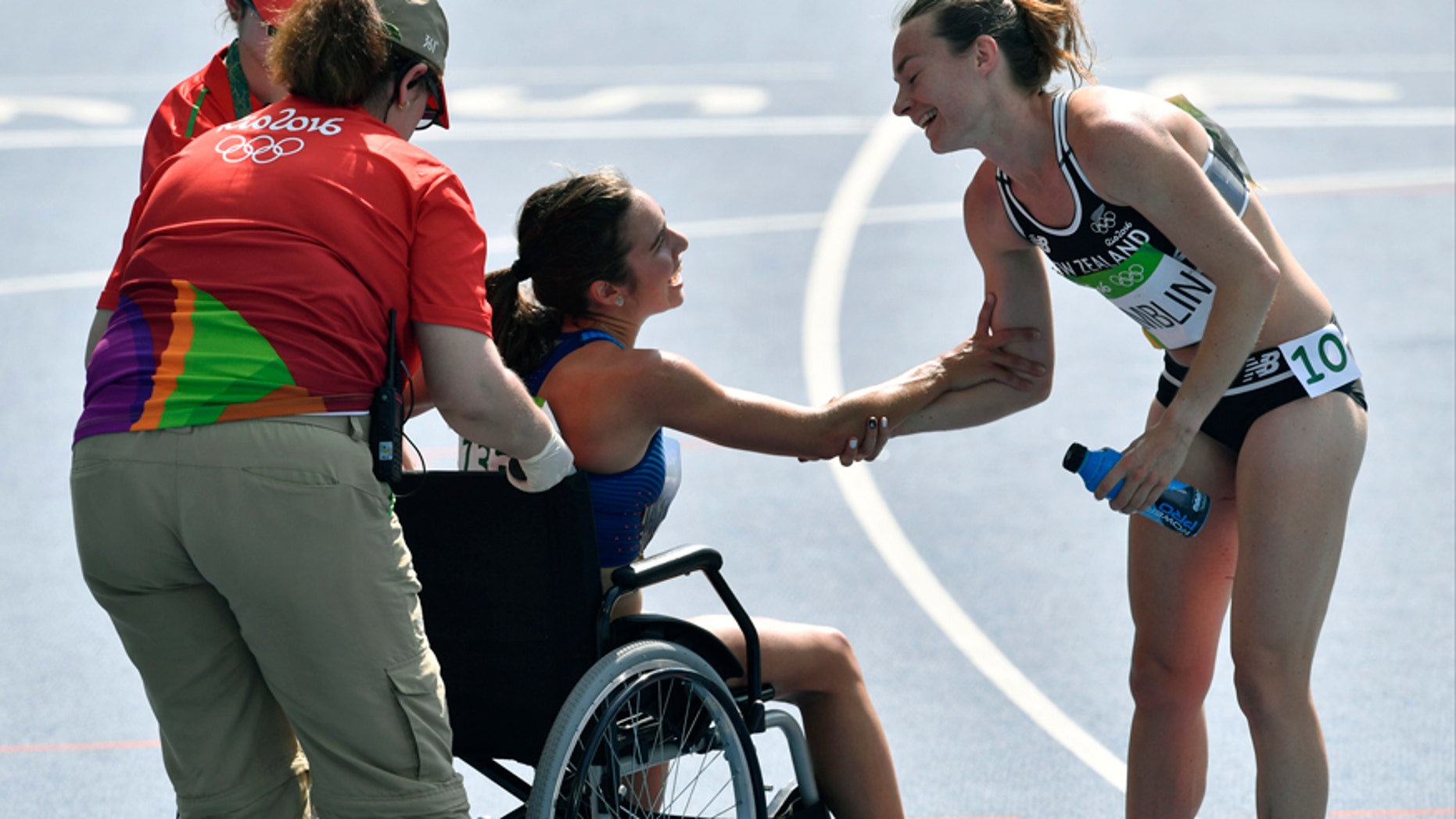 New Zealand's Nikki Hamblin greets the United States' Abbey D'Agostino, left, as she is helped from the track.