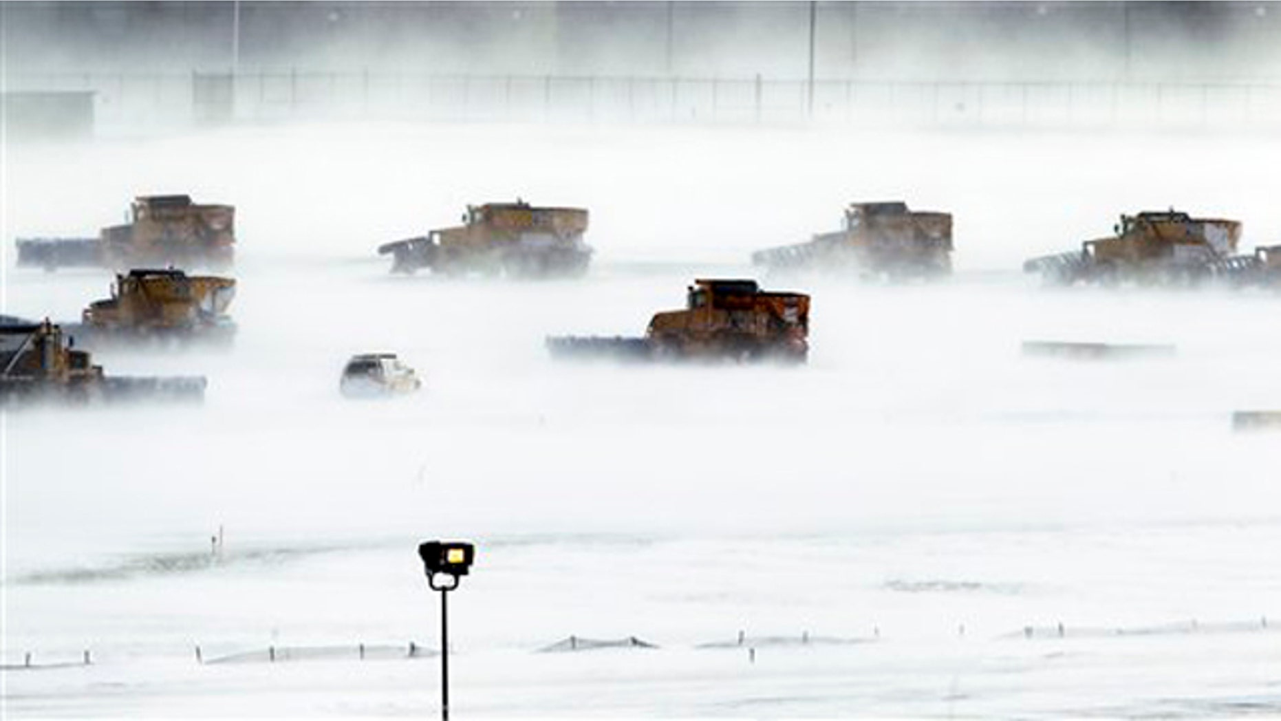 Dec. 27, 2010: Snow removal crews work to clear runways at Philadelphia International Airport. A powerful East Coast blizzard menaced would-be travelers by air, rail and highway, leaving thousands without a way to get home after the holidays and shutting down major airports and rail lines for days.