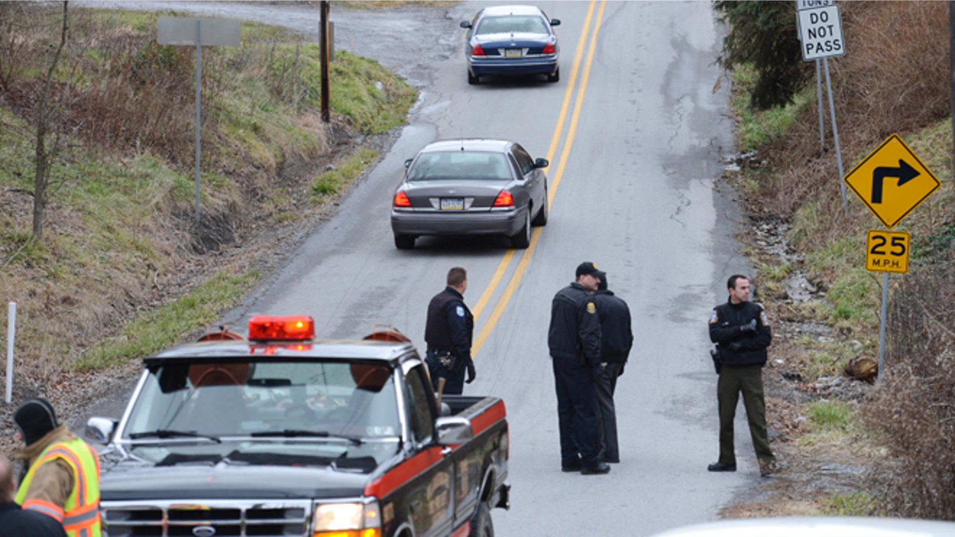 Dec. 21, 2012: Local law enforcement block off road along Rt. 22 near the Canoe Creek State Park, Pa. while investigating a shooting.