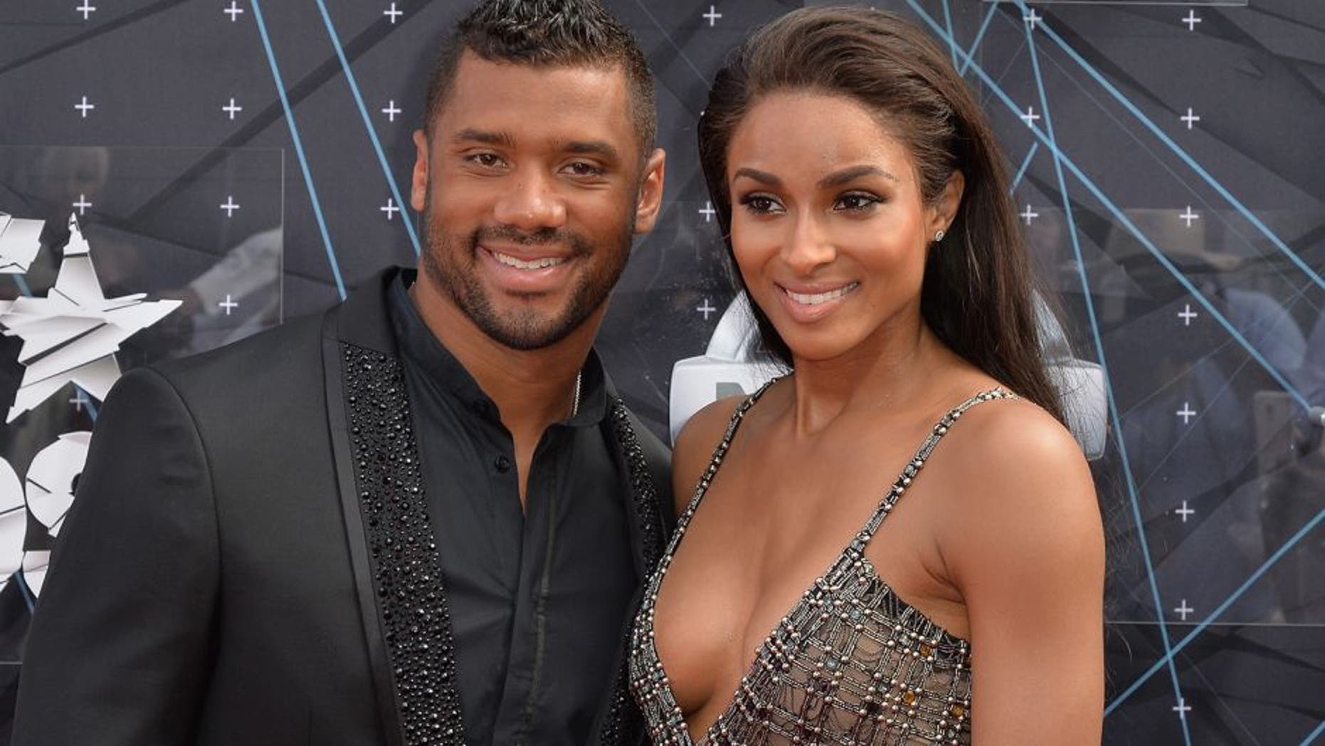 LOS ANGELES, CA - JUNE 28: Professional football player Russell Wilson (L) and recording artist Ciara attend the 2015 BET Awards at the Microsoft Theater on June 28, 2015 in Los Angeles, California. (Photo by Earl Gibson/BET/Getty Images for BET)